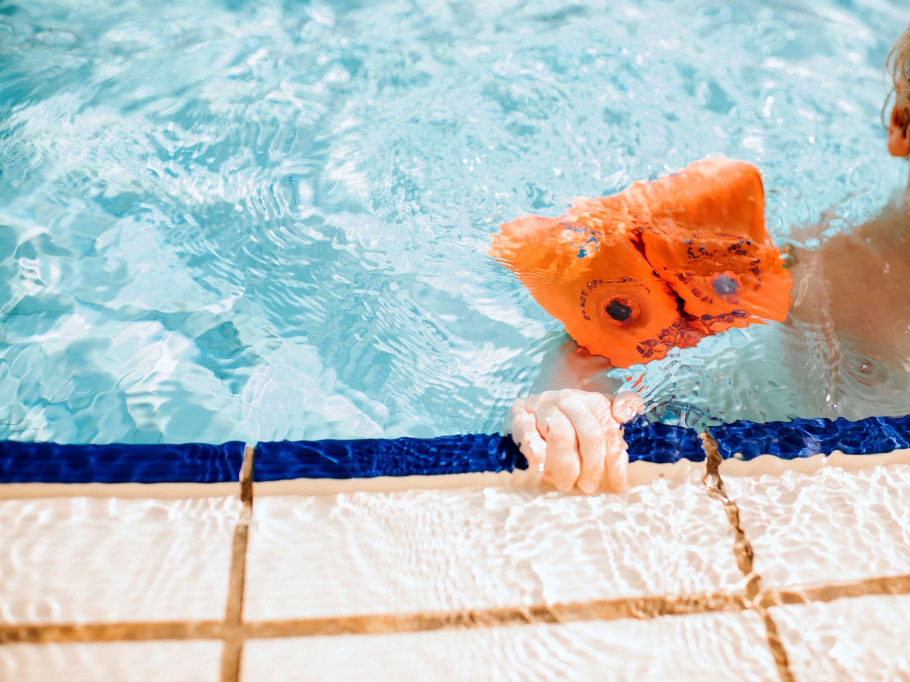 PHOTO: Stock photo of a child learning to swim in a pool.