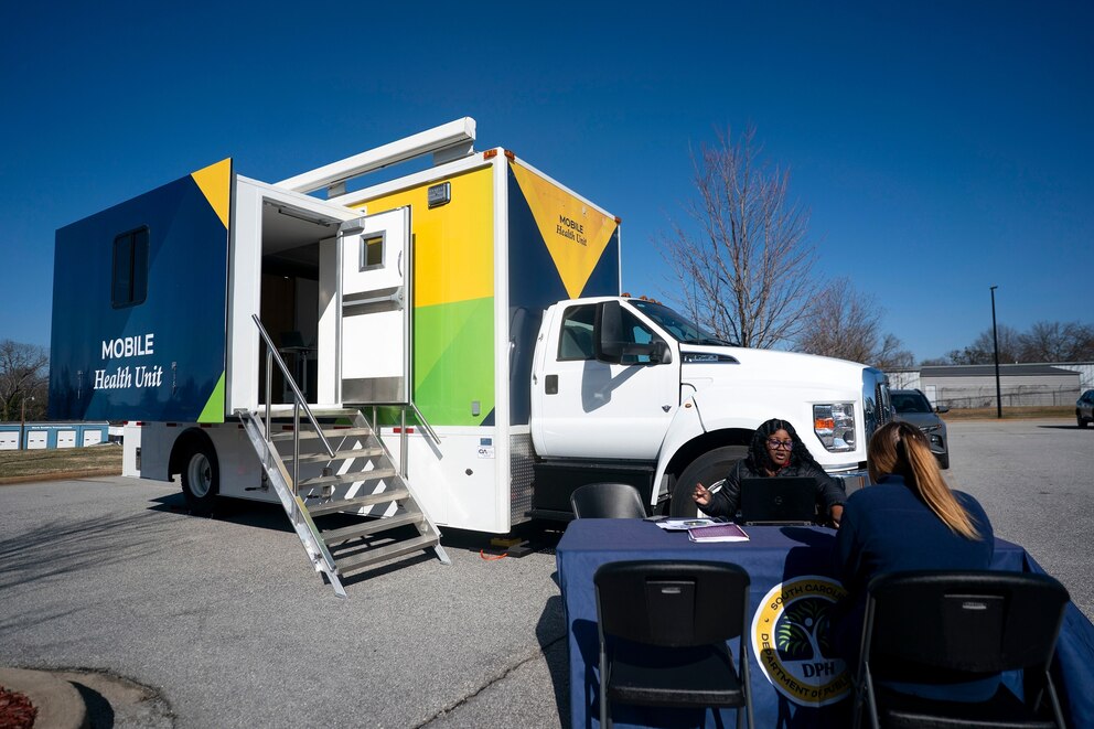 PHOTO: A worker with the South Carolina Department of Public Health talks to a patient outside a mobile clinic offering free measles vaccinations on Feb. 6, 2026, in Spartanburg, South Carolina.