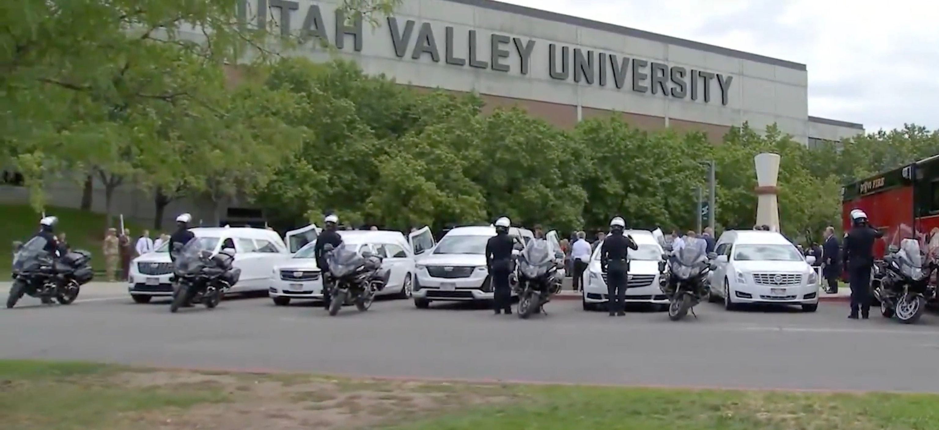 PHOTO: Motorcycle police officers salute five white hearses carrying the bodies of Provo, Utah, Fire Capt. Spencer Long, his wife, Katrina, and their three sons, July 29, 2026, following a funeral at Utah Valley University. 