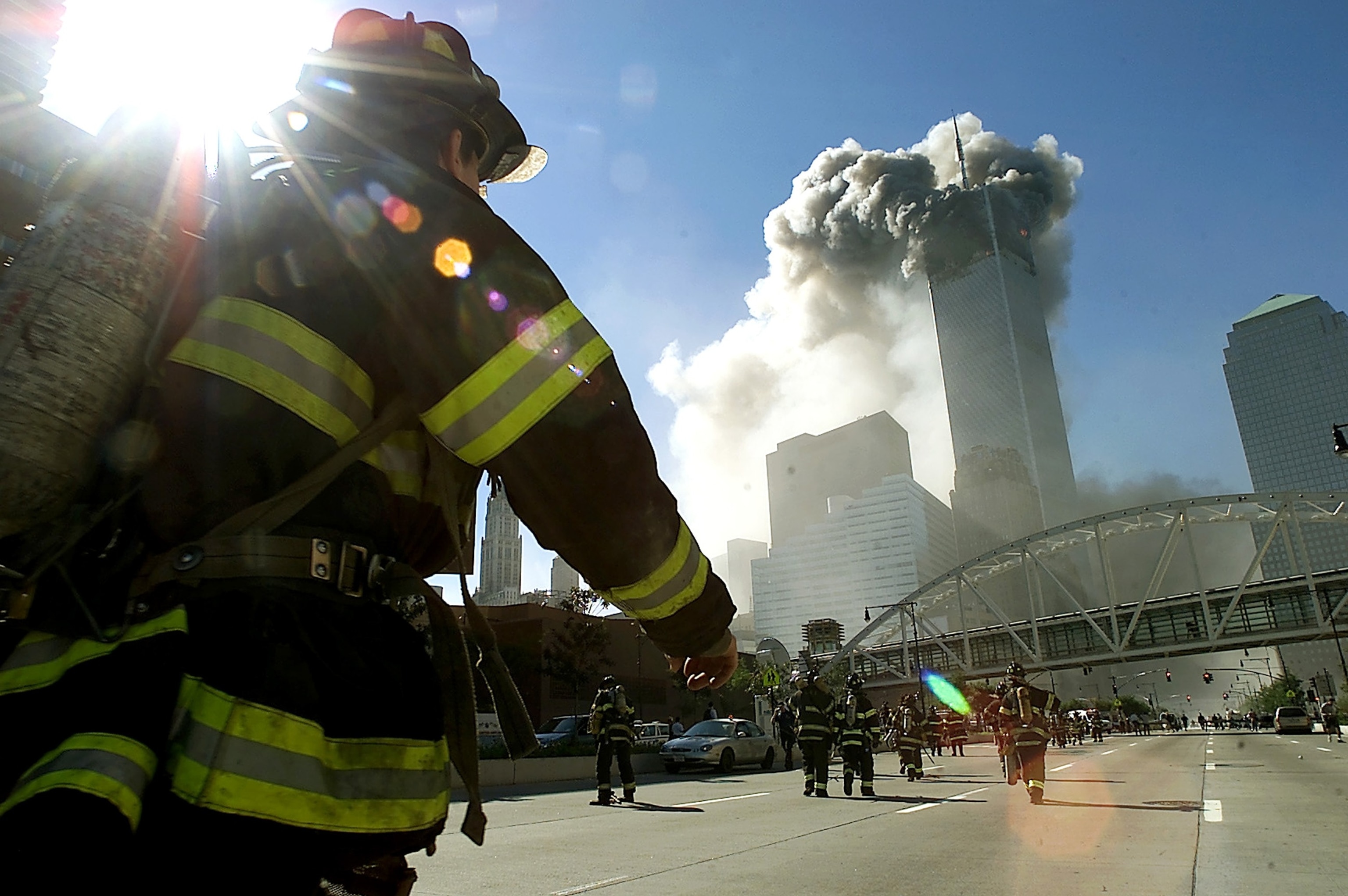 Firefighters walk toward one of the towers at the World Trade Center before it collapsed after a plane hit the building Sept. 11, 2001, in New York City. 