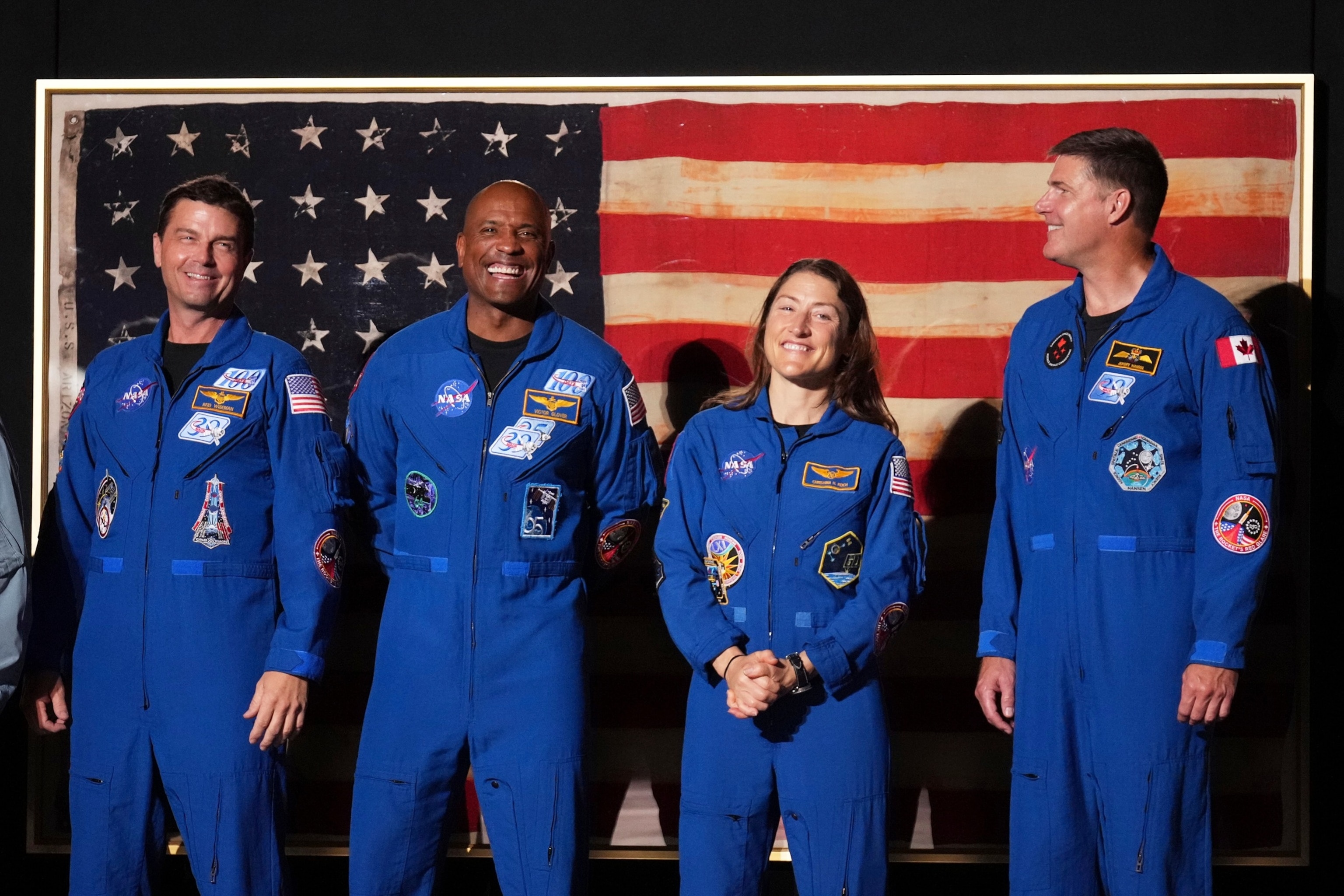 PHOTO: Artemis II crew members Reid Wiseman, Victor Glover, Christina Koch and Jeremy Hansen listenas President Donald Trump speaks an Independence Day event honoring the nation's 250th anniversary, July 4, 2026, in Washington.