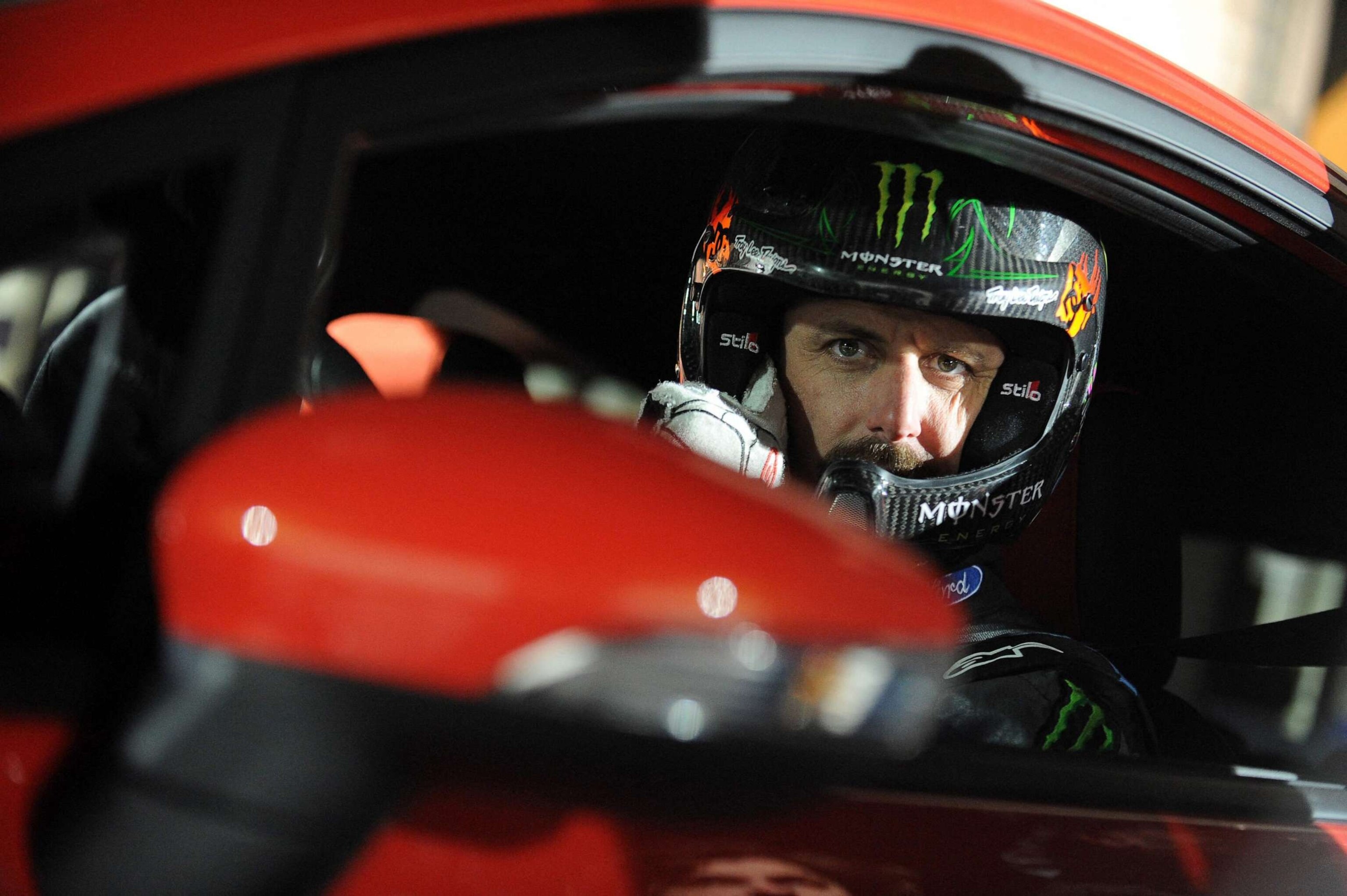 PHOTO: (FILES) In this file photo taken on March 24, 2013, US driver Ken Block of Hoonigan Racing Division Team, formerly known as the Monster World Rally Team, poses for a photo in a Ford Fiesta ST type car on ice of Budapest City Park Ice Rink.