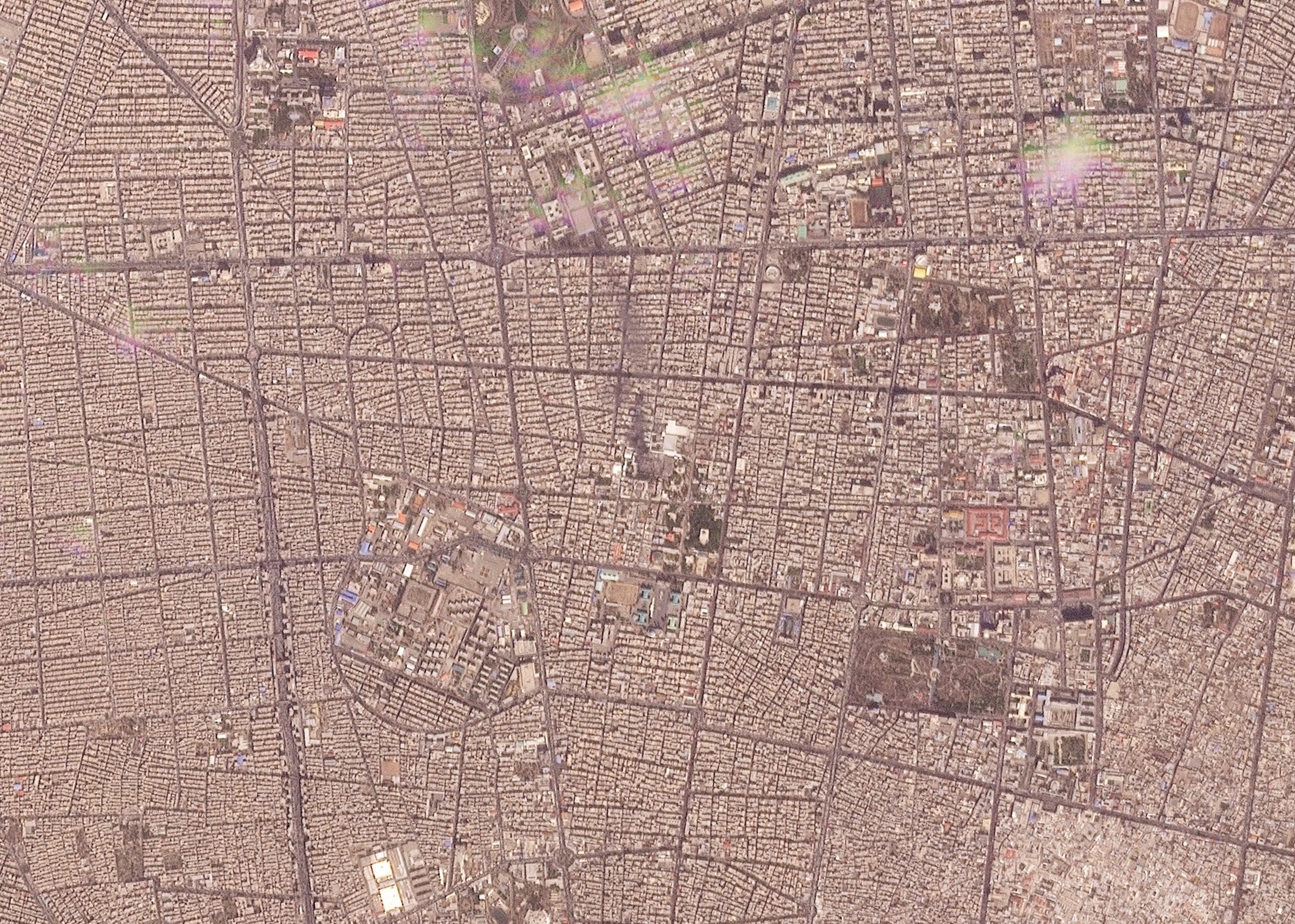 PHOTO: This handout satellite image taken by 2026 Planet Labs PBC on Feb. 28, 2026, shows a view of Tehran and what appears to be a plum of light black smoke reportedly ascending from the compound of Iran's Supreme Leader Ali Khamenei following a strike. 