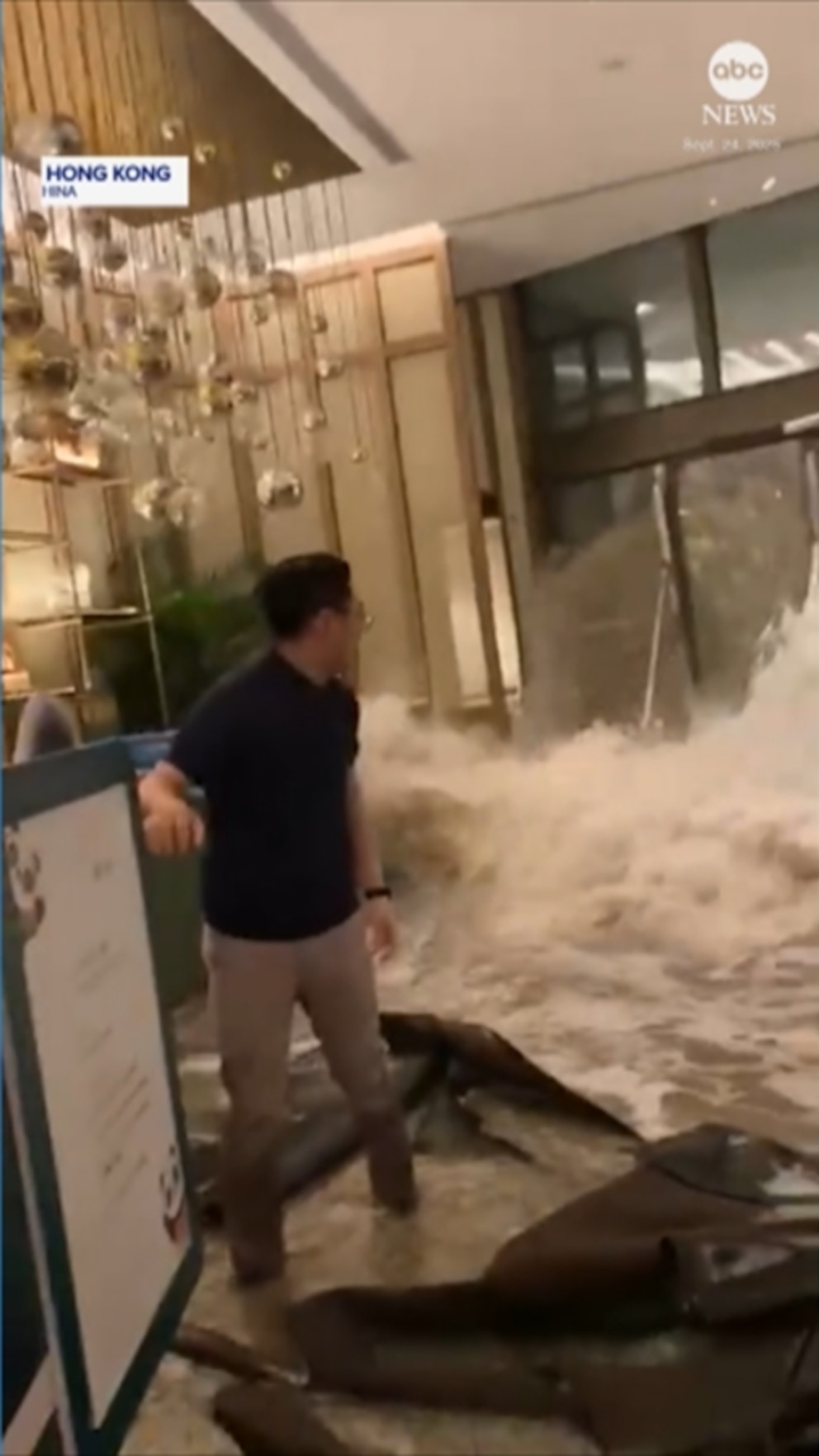 NextImg:Video Flood waters crash through hotel doors in Hong Kong