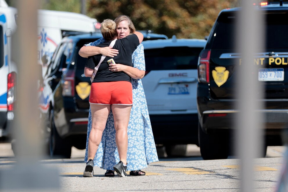 PHOTO: People embrace near the scene of a shooting at a church in Grand Blanc, Michigan, September 28, 2025.