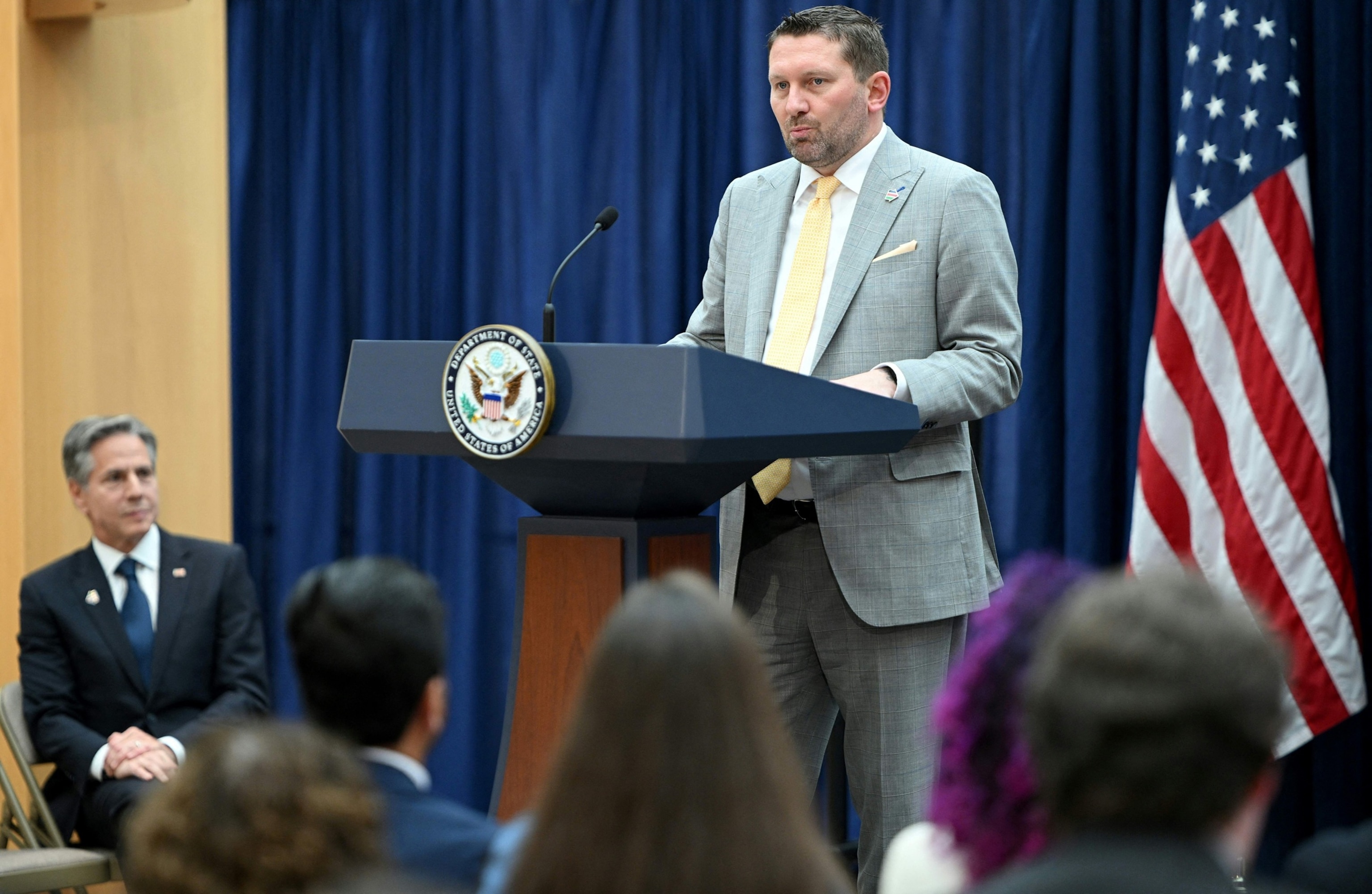 PHOTO: In this June 12, 2023, file photo, US Secretary of State Antony Blinken looks on as AfghanEvac founder Shawn VanDiver speaks during a Memorandum of Understanding signing in the Department of State in Washington, D.C.