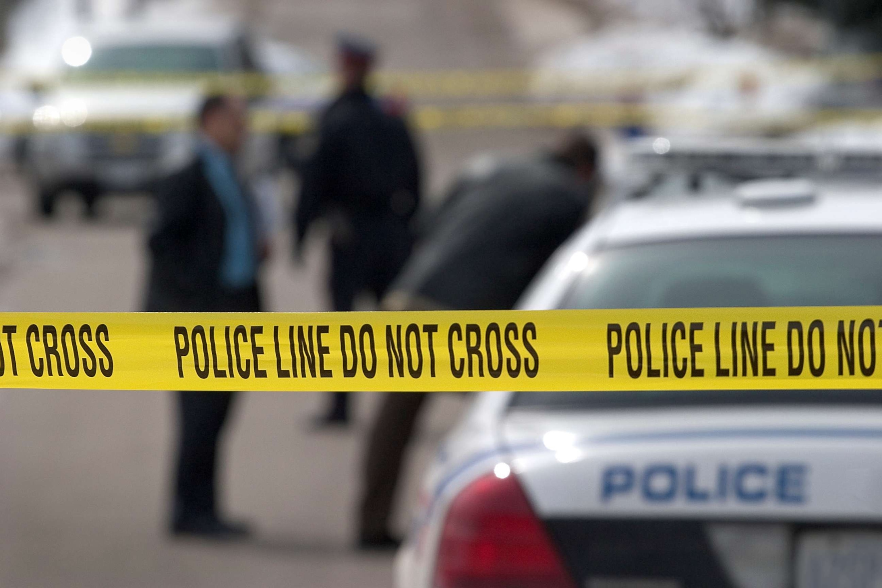 PHOTO: A stock photo depicts a crime scene with police tape and officers in the background.