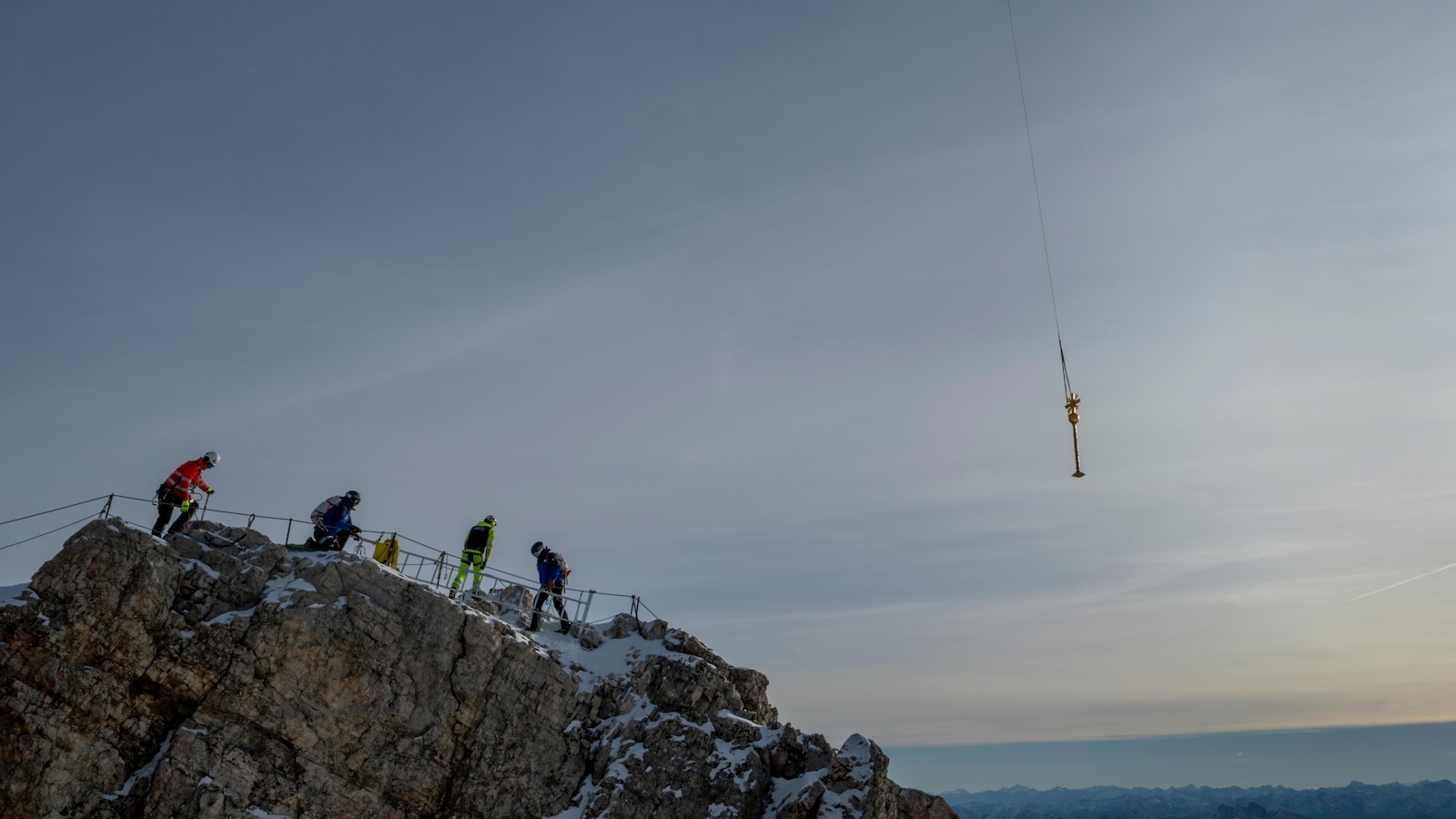The gilded cross on Germany's highest peak has too many stickers. Now it's being restored