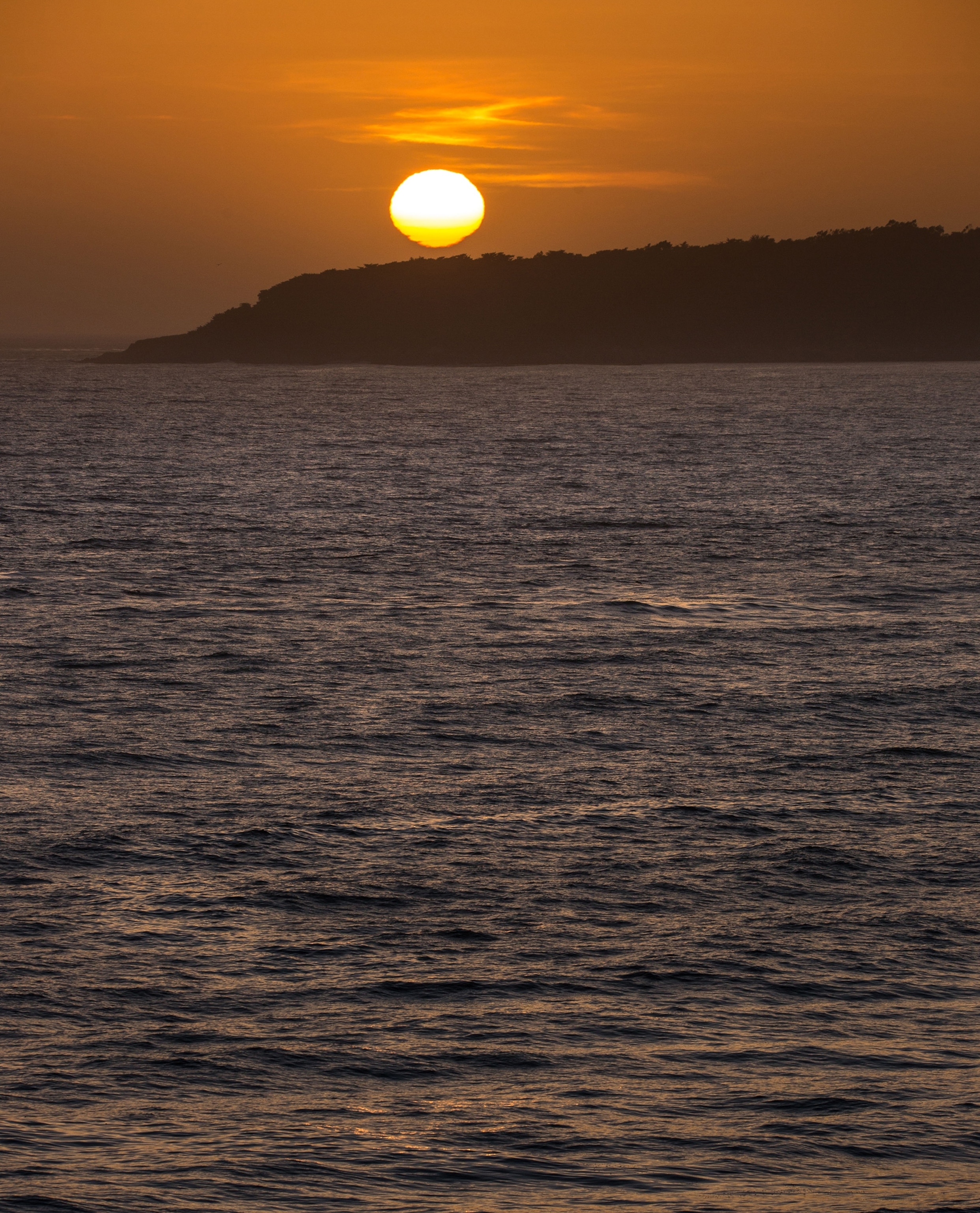 PHOTO: The sun sets behind the hills of the bay at San Simeon, Calif., May 9. 2021.