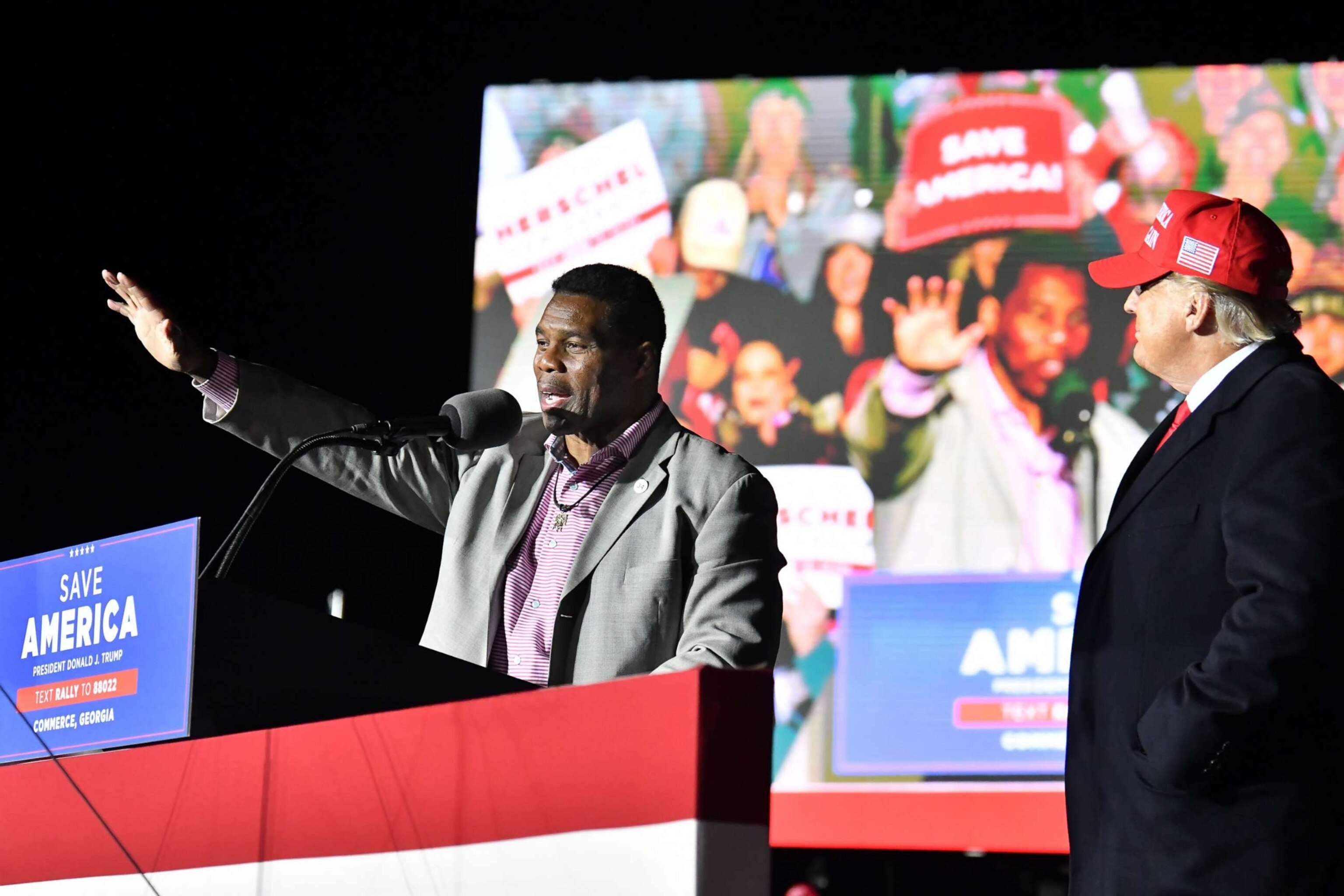 PHOTO: Herschel Walker and former President Donald Trump attend a rally for Georgia GOP candidates in Commerce, Ga., March 26, 2022.