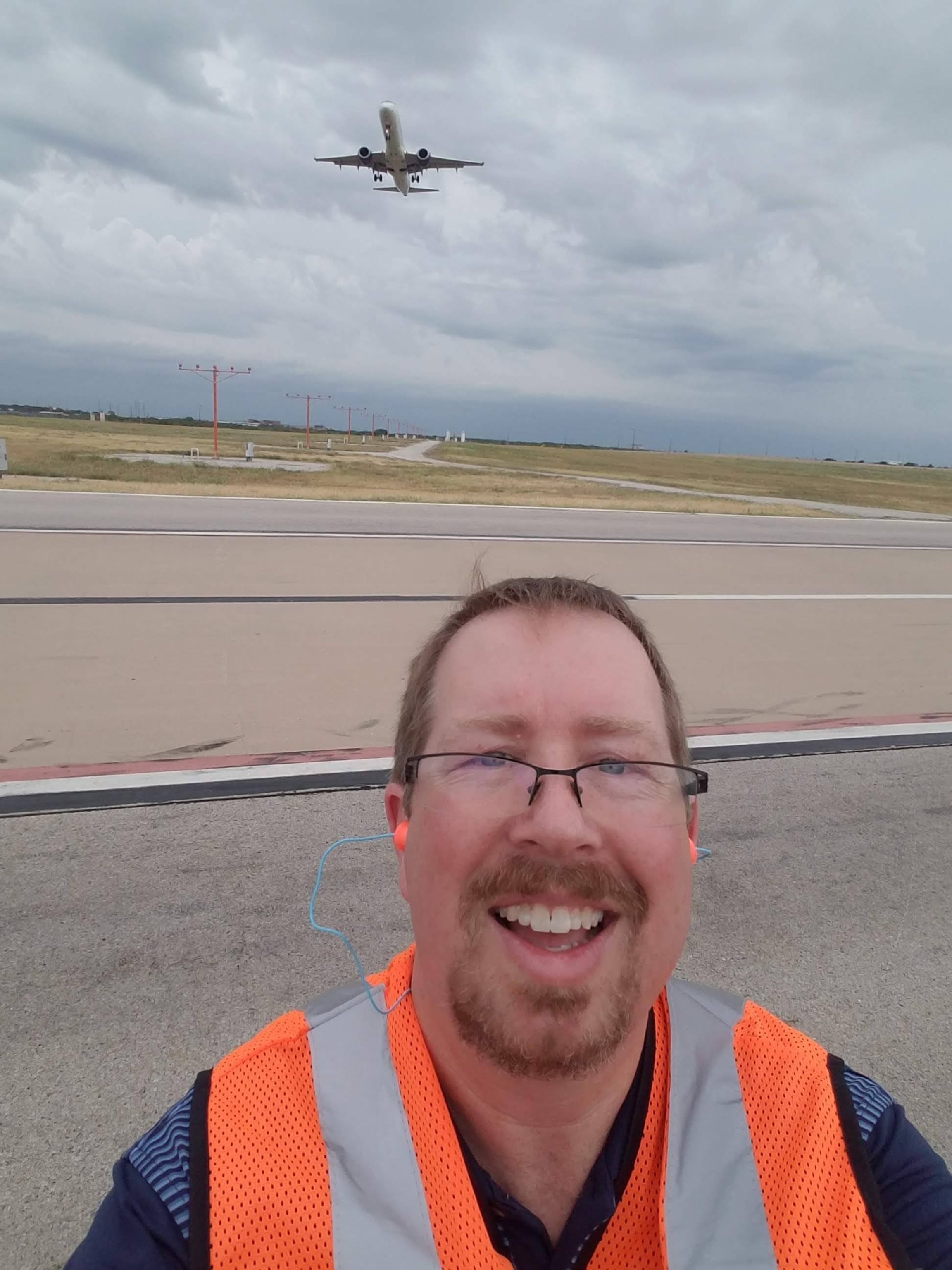 PHOTO: Jamie Faith, an American Airlines manager, is shown near the runway as a plane takes off in this undated photo.