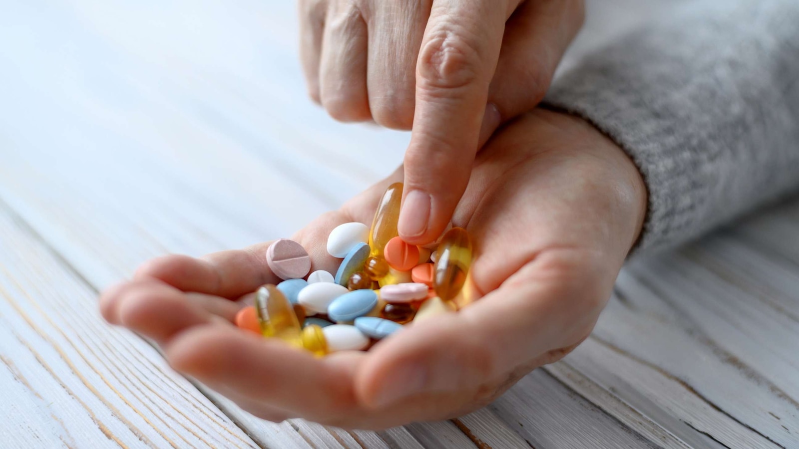 In this undated stock photo, a hand is shown holding pills.