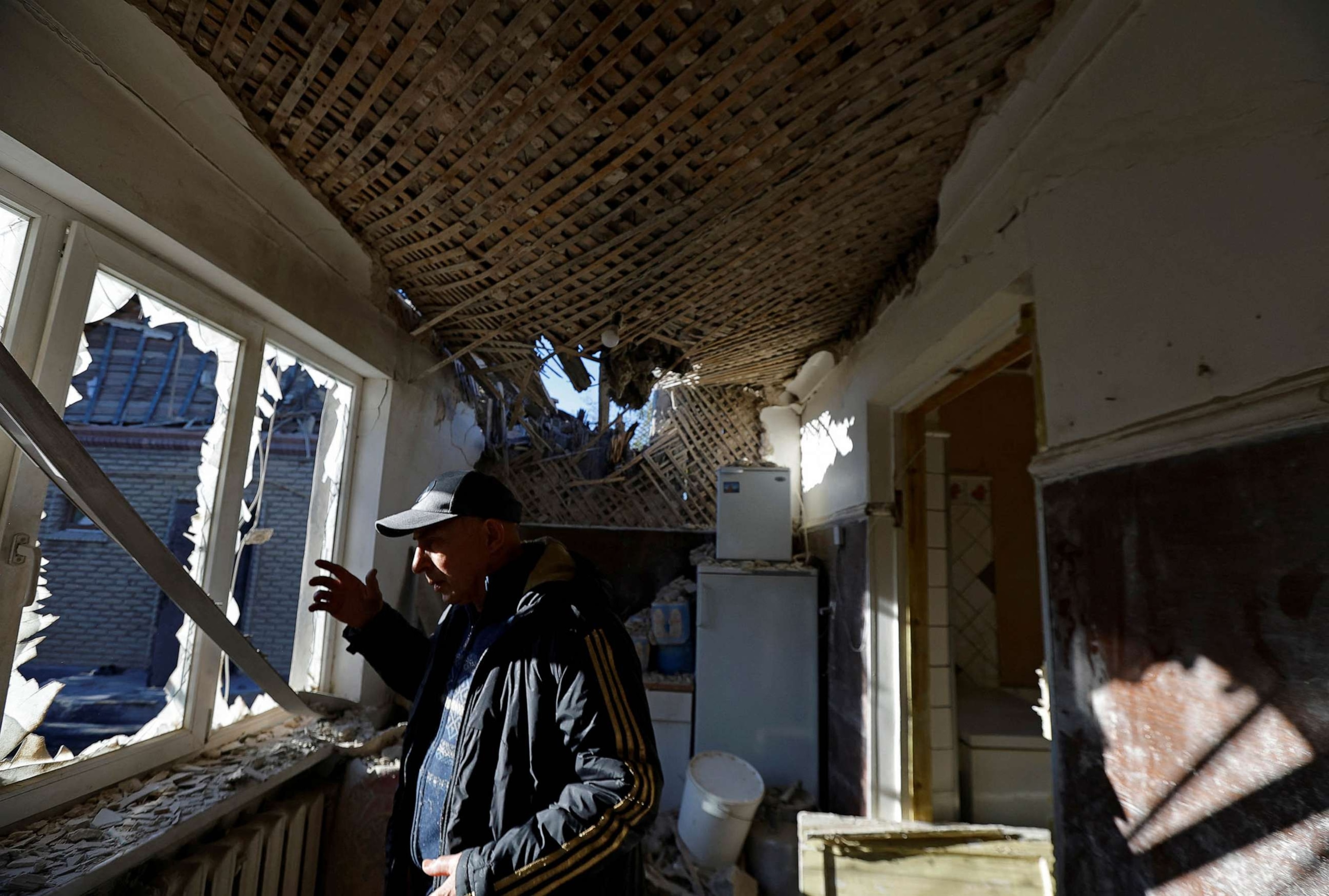 PHOTO: Local resident Grigory Samarin, 71, stands inside his house damaged by recent shelling in the course of Russia-Ukraine conflict in Donetsk, Russian-controlled Ukraine, Oct. 15, 2023.