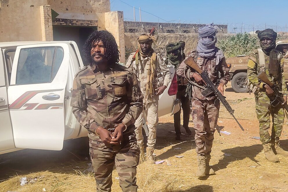 PHOTO: This handout picture released by the Sudanese Rapid Support Forces (RSF) on Oct. 30, 2025, shows RSF members reportedly detaining a fighter known as Abu Lulu (L) in El-Fasher, in war-torn Sudan's western Darfur region. 