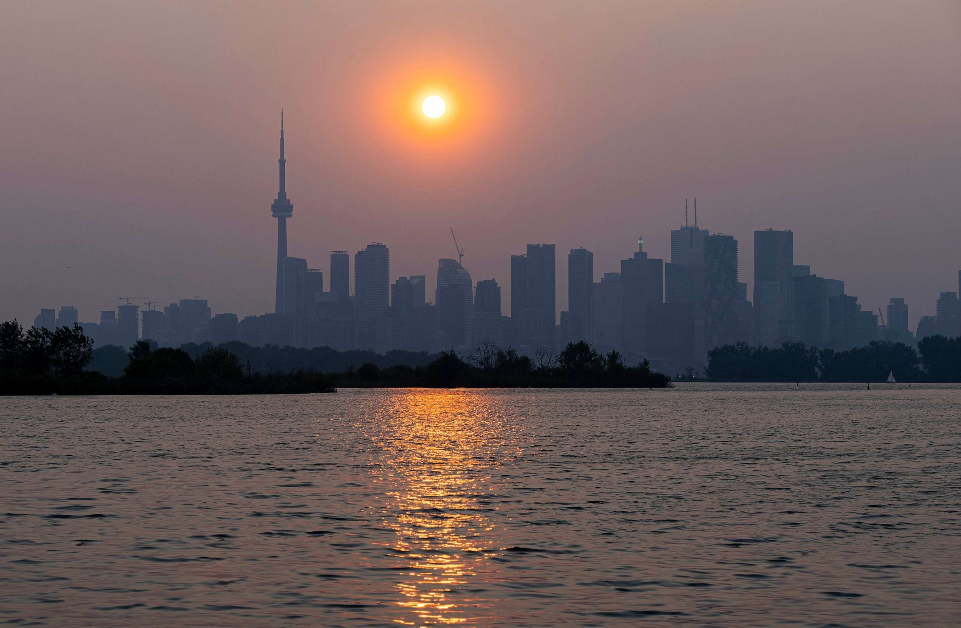 PHOTO: The sun is obscured by smoke from wildfires over the Toronto skyline, June 6, 2023, in Canada.