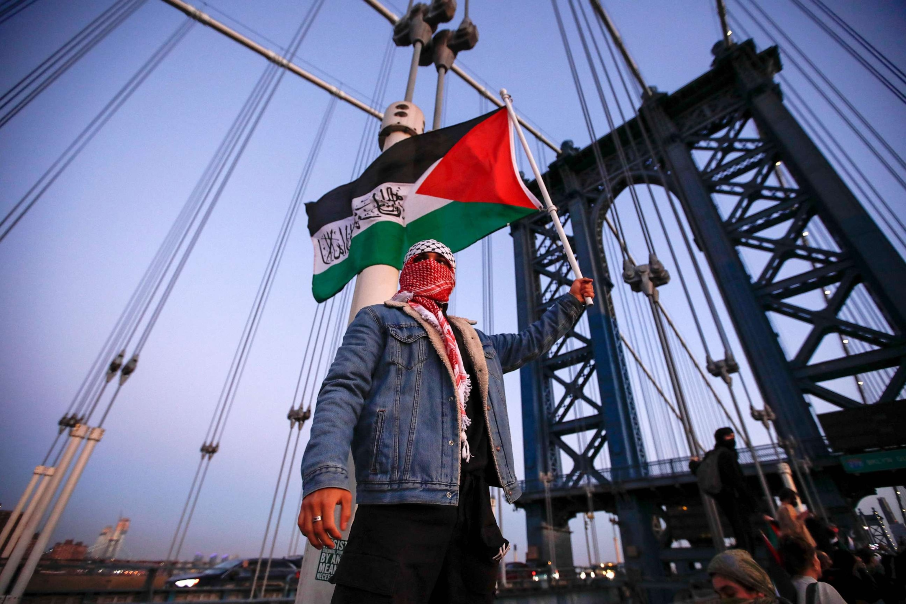 PHOTO:Demonstrators hold Palestinian flags as they march through Brooklyn Bridge during a rally in support of Palestinians in New York City on Nov. 7, 2023.