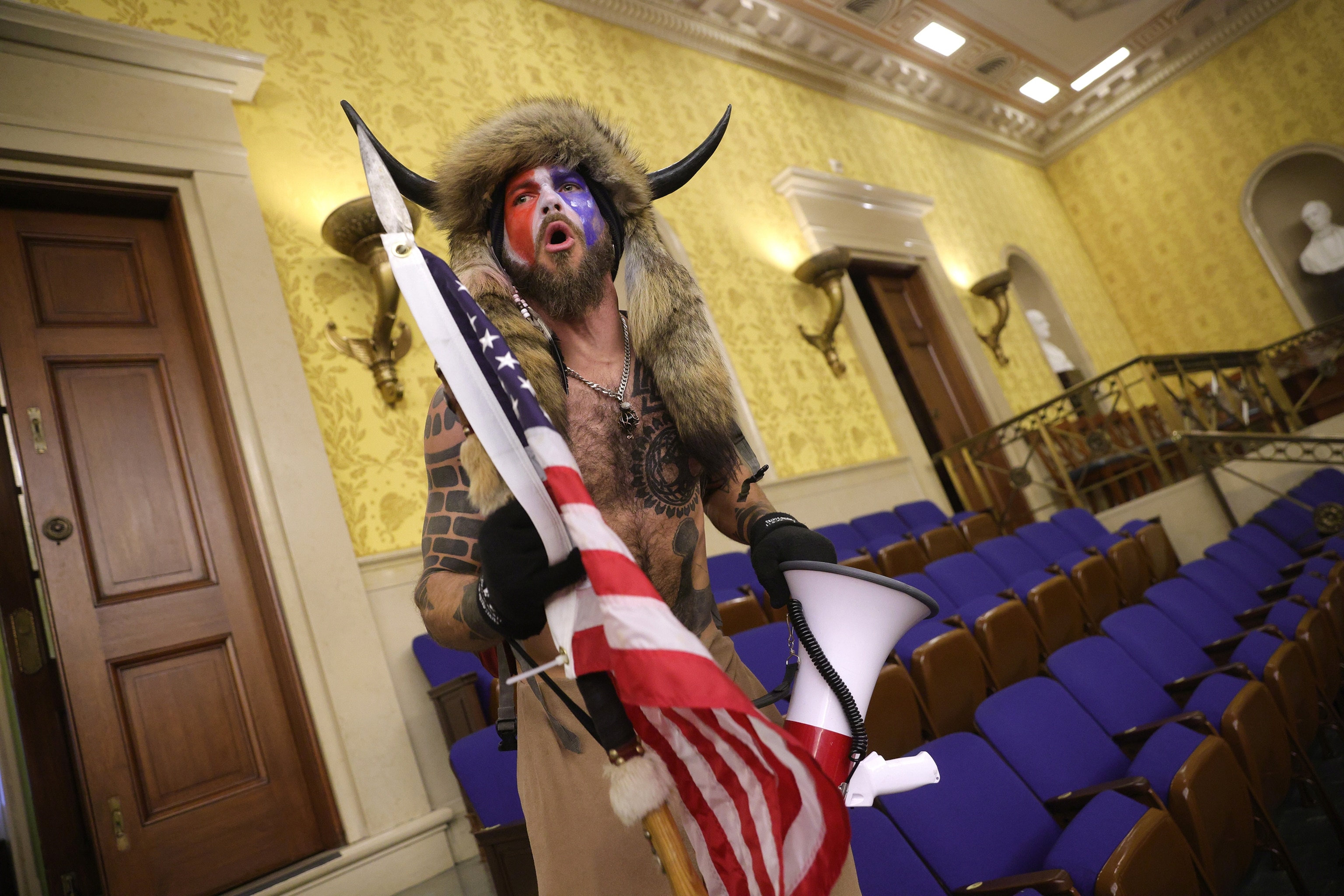 PHOTO: In this Jan. 6, 2021, file photo, Jacob Chansley screams inside the Senate chamber after the U.S. Capitol was breached by a mob during a joint session of Congress in Washington, D.C.