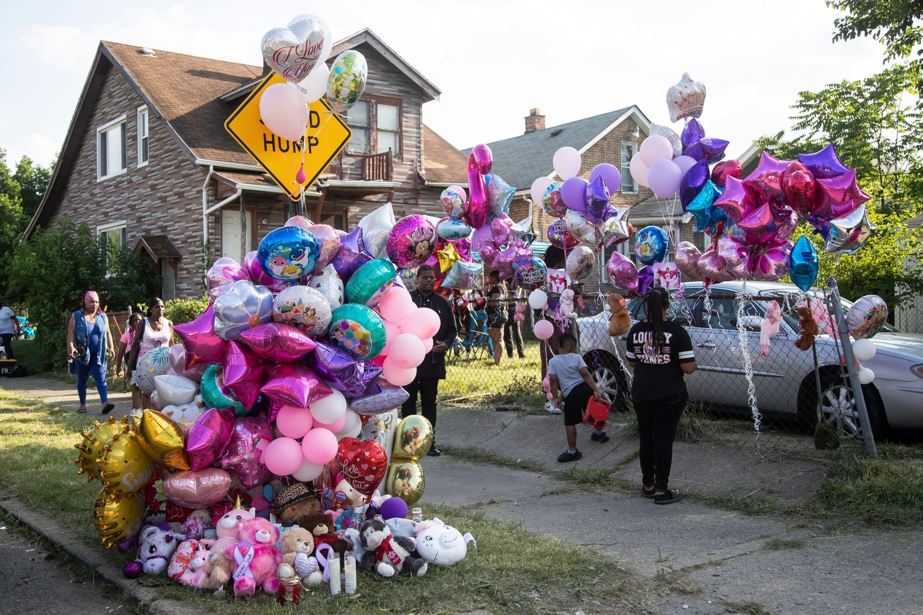 PHOTO: Community members leave balloons, stuffed animals, and candles in memory of Wynter Cole-Smith on Erwin Avenue on July 7, 2023, near where the body of the 2-year-old Lansing toddler was found in Detroit.