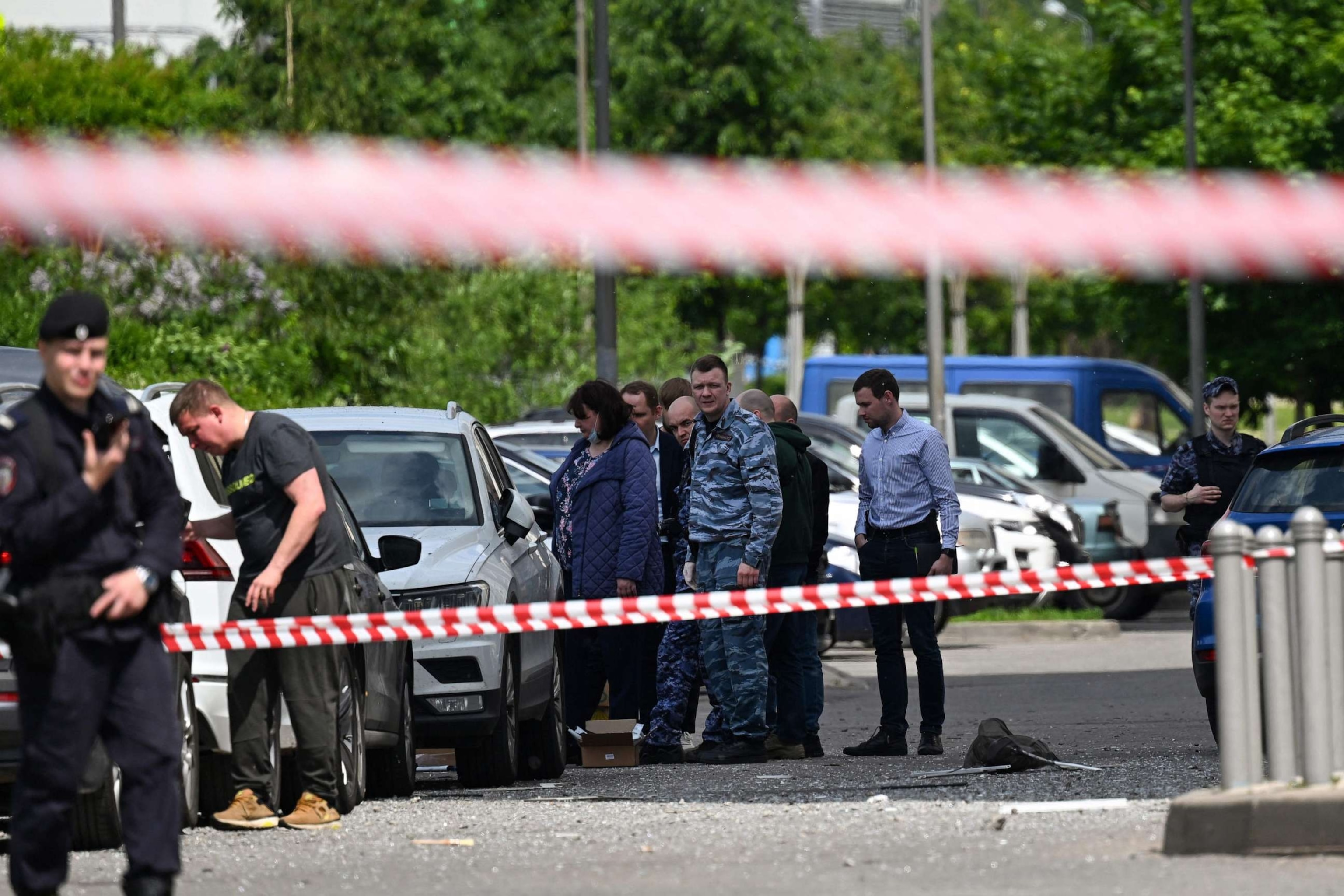 PHOTO: Law enforcement officers and investigators are seen outside a damaged multi-storey apartment building after a reported drone attack in Moscow on May 30, 2023.