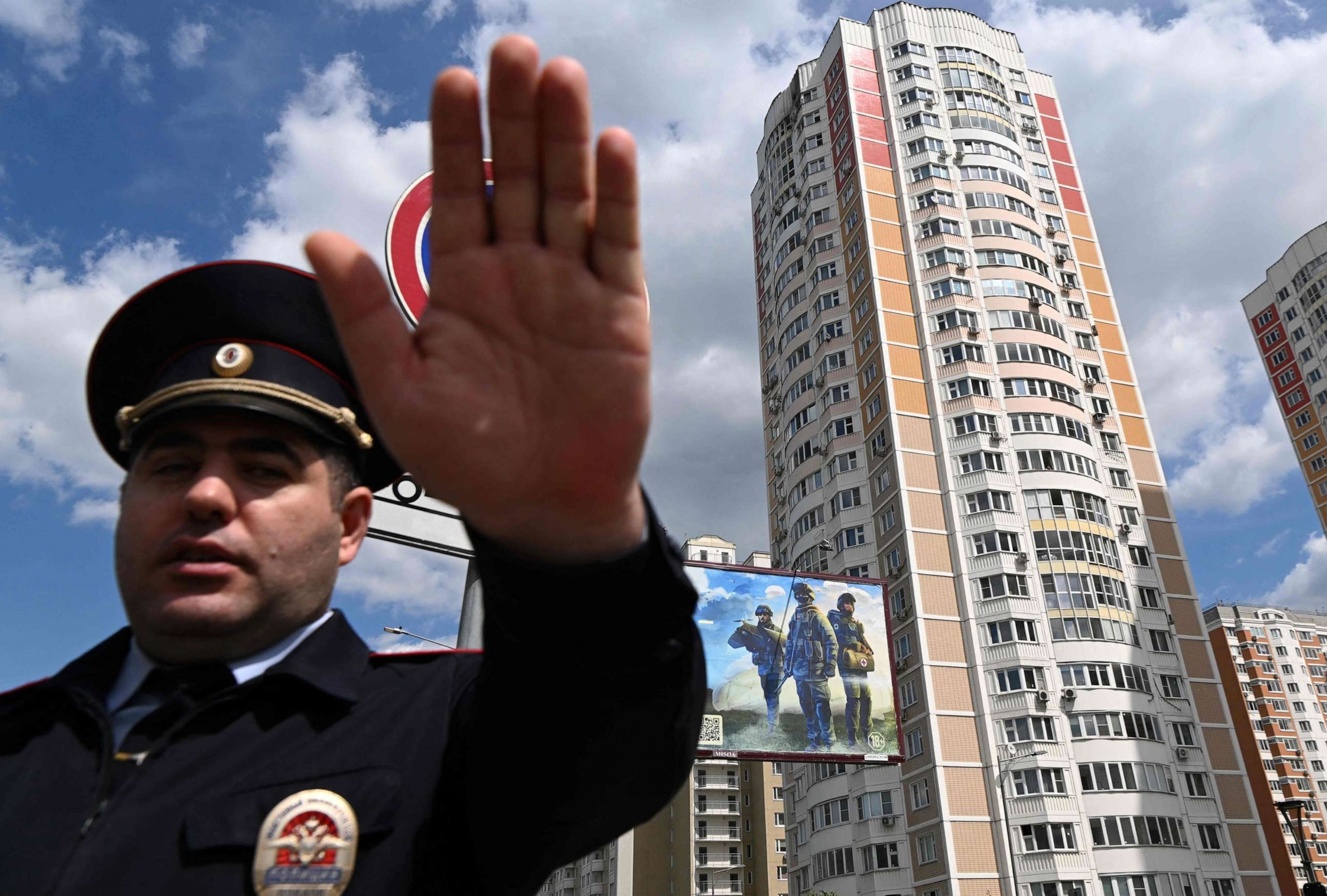 PHOTO: A police officer secures an area outside a damaged multi-story apartment building after a reported drone attack in Moscow, May 30, 2023.