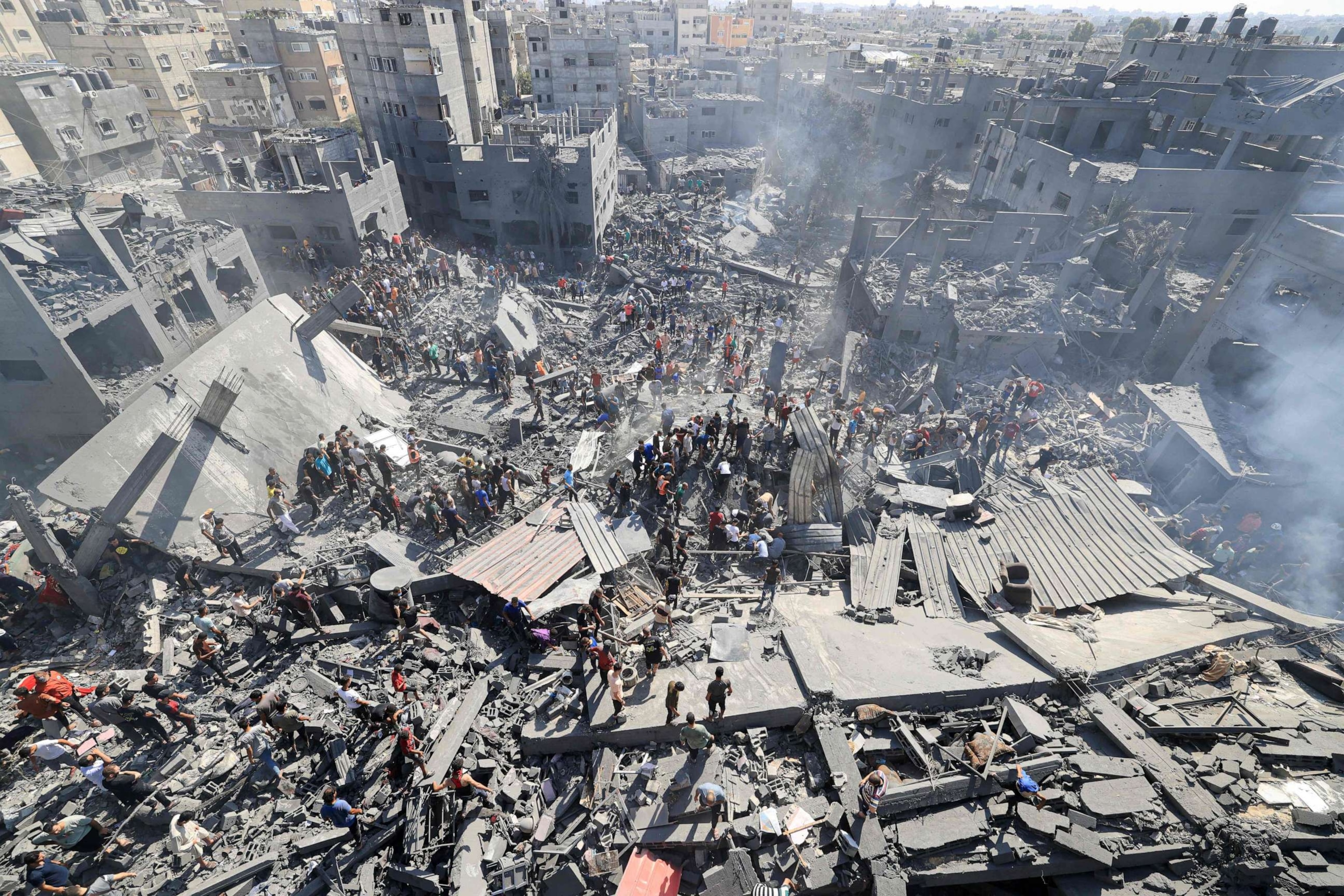 PHOTO: People search for survivors and the bodies of victims through the rubble of buildings destroyed during Israeli air strike, in Khan Yunis in the southern Gaza Strip, Oct. 26, 2023.