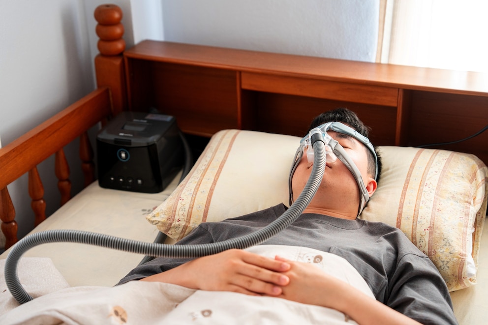 PHOTO: Stock photo of a man suffering from obstructive sleep apnea and sleeping with a Cpap mask.