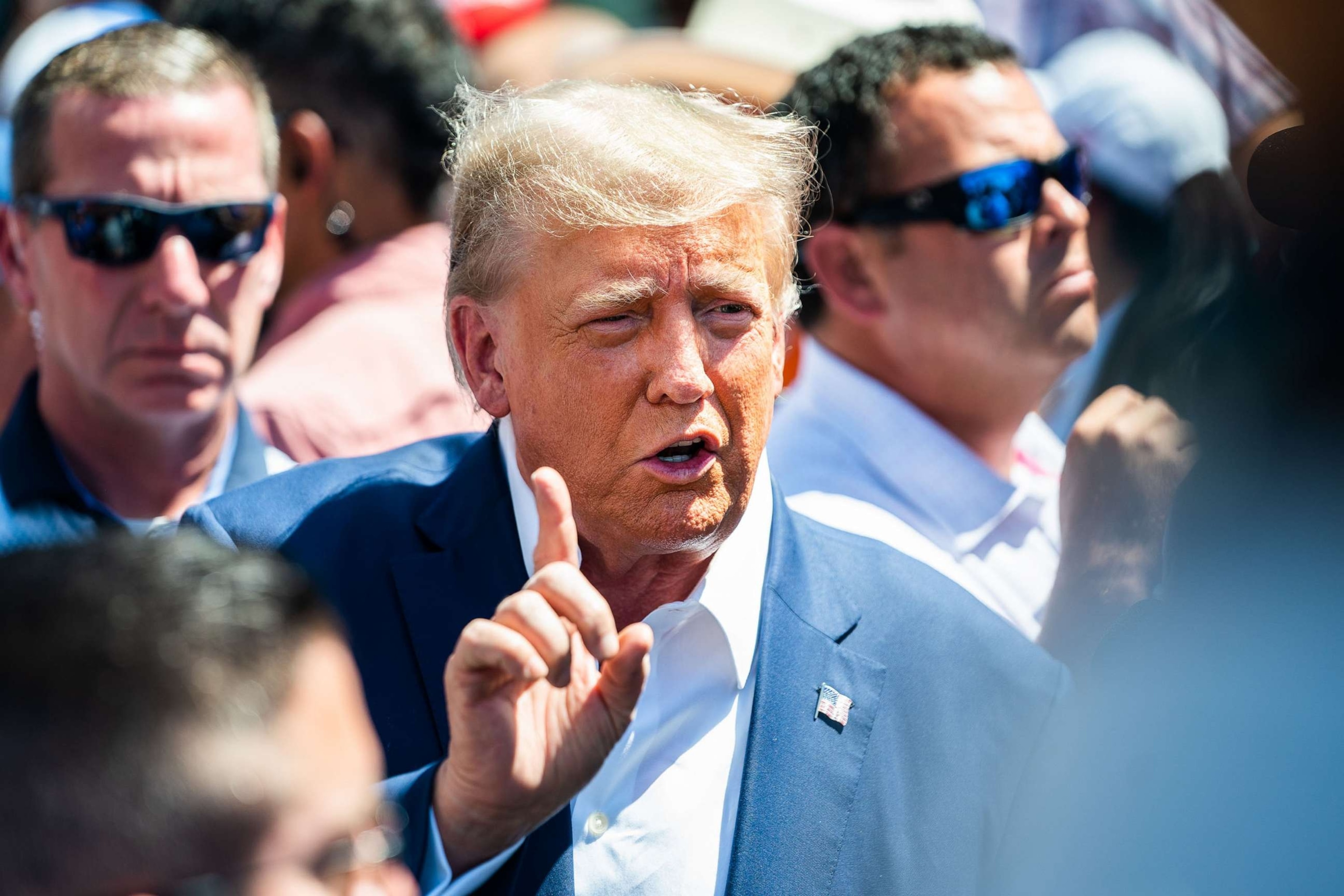 PHOTO: Former President Donald Trump speaks with the press at the Iowa Pork Producers booth during the 2023 Iowa State Fair at the Iowa State Fair Grounds, Aug. 12, 2023.