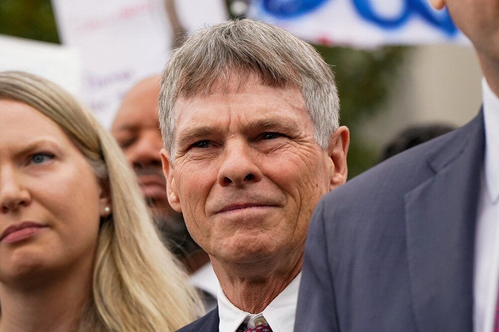 PHOTO: Former U.S. Olympic canoeist David Hearn stands with his lawyer as they speak to reporters following Hearn's arraignment on a felony destruction of property charge at DC Superior Court in Washington, July 9, 2026.