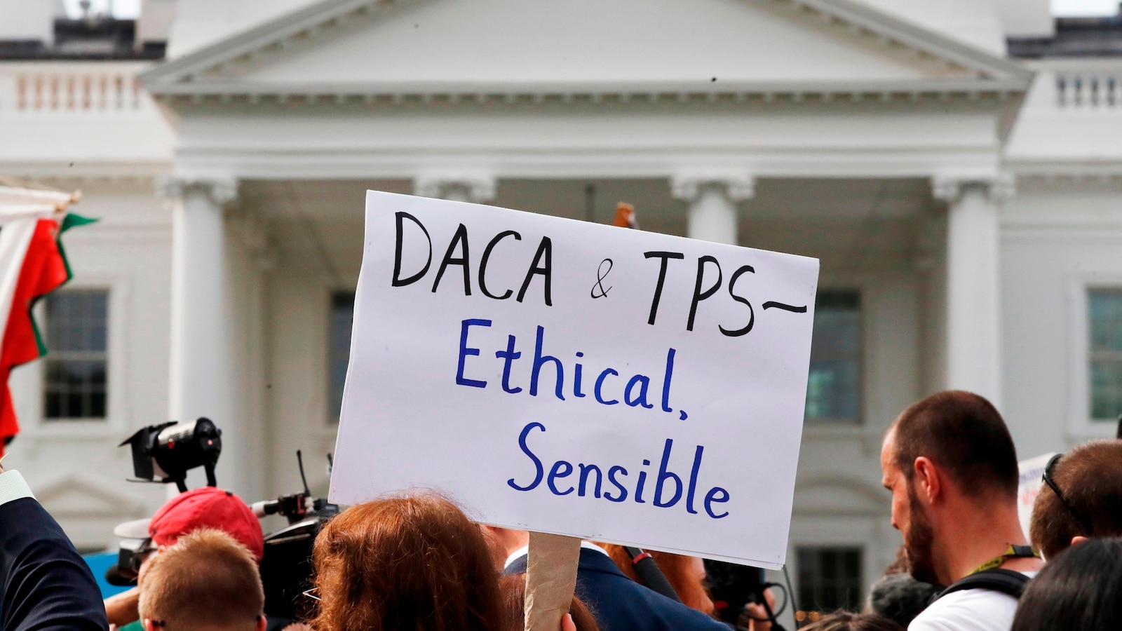 The Latest: Supreme Court to hear arguments on ending legal protections for Haitian/Syrian migrants