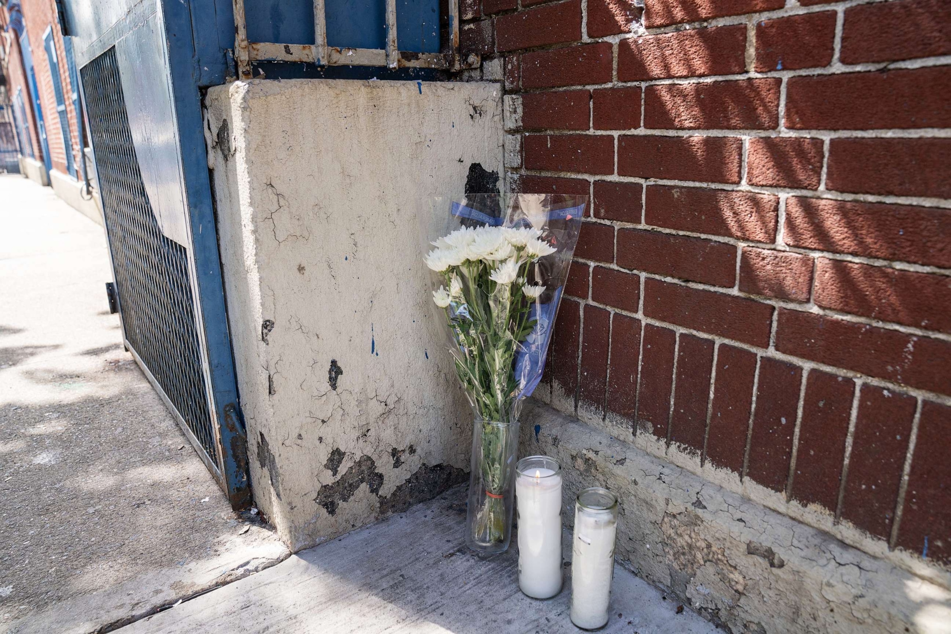 PHOTO: Flowers and candles placed at the scene of the day care center where a child died in the Bronx section of New York, Sept. 17, 2023.