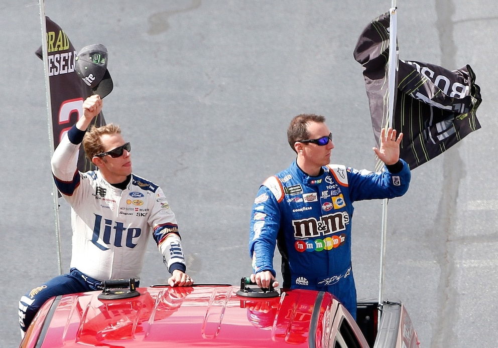 PHOTO: Brad Keselowski and Kyle Busch take a ride around the track to acknowledge the fans prior to the Monster Energy NASCAR Cup Series Apache Warrior 400 presented by Lucas Oil at Dover International Speedway on Oct. 1, 2017, in Dover, Delaware.