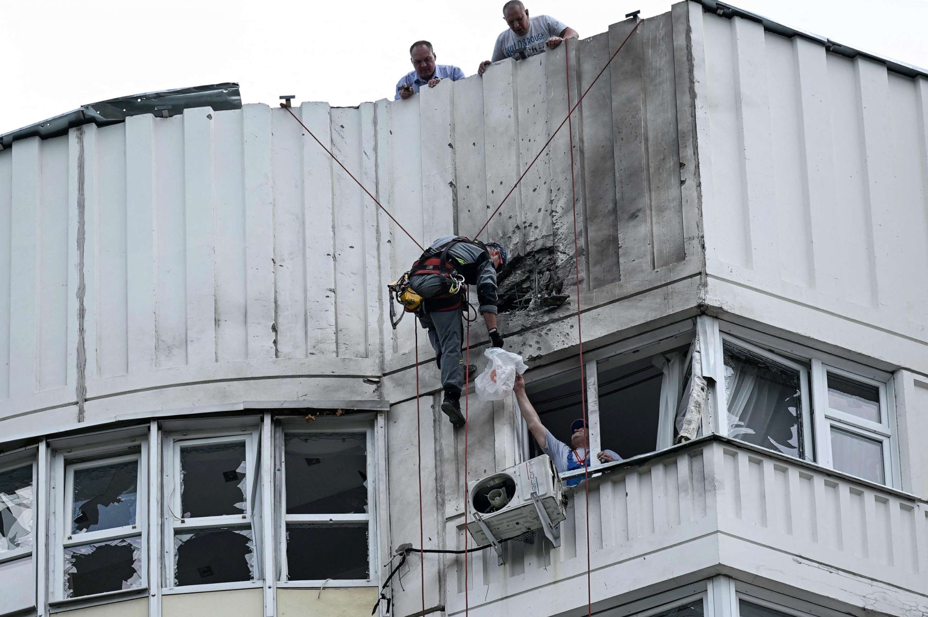 PHOTO: A specialist inspects the damaged facade of a multi-story apartment building after a reported drone attack in Moscow, May 30, 2023.