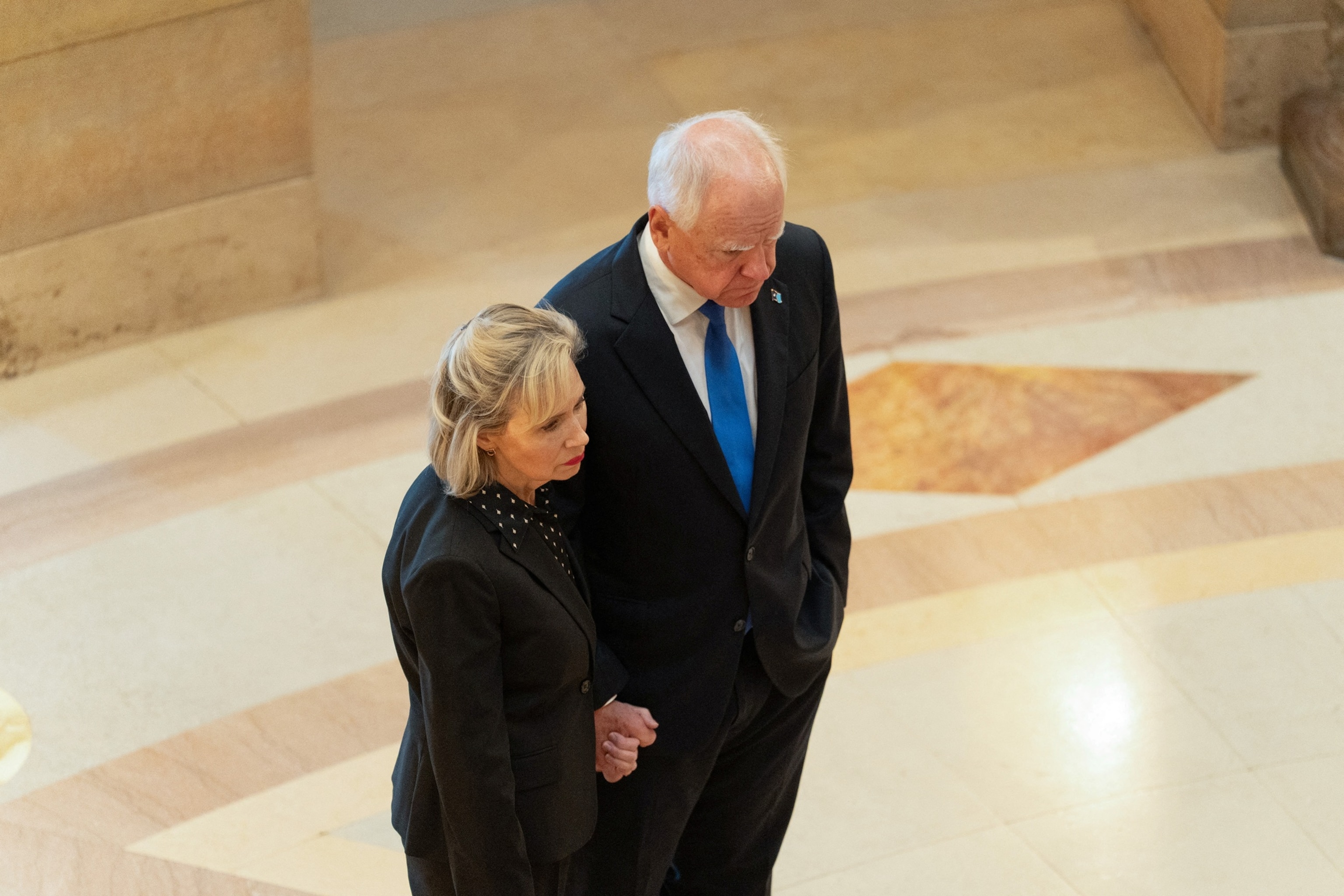 PHOTO: Minnesota Gov. Tim Walz and his wife Gwen pay their respects as the caskets of senior Democratic state assemblywoman Melissa Hortman and her husband Mark lie in State at the Minnesota Capitol, June 27, 2025.