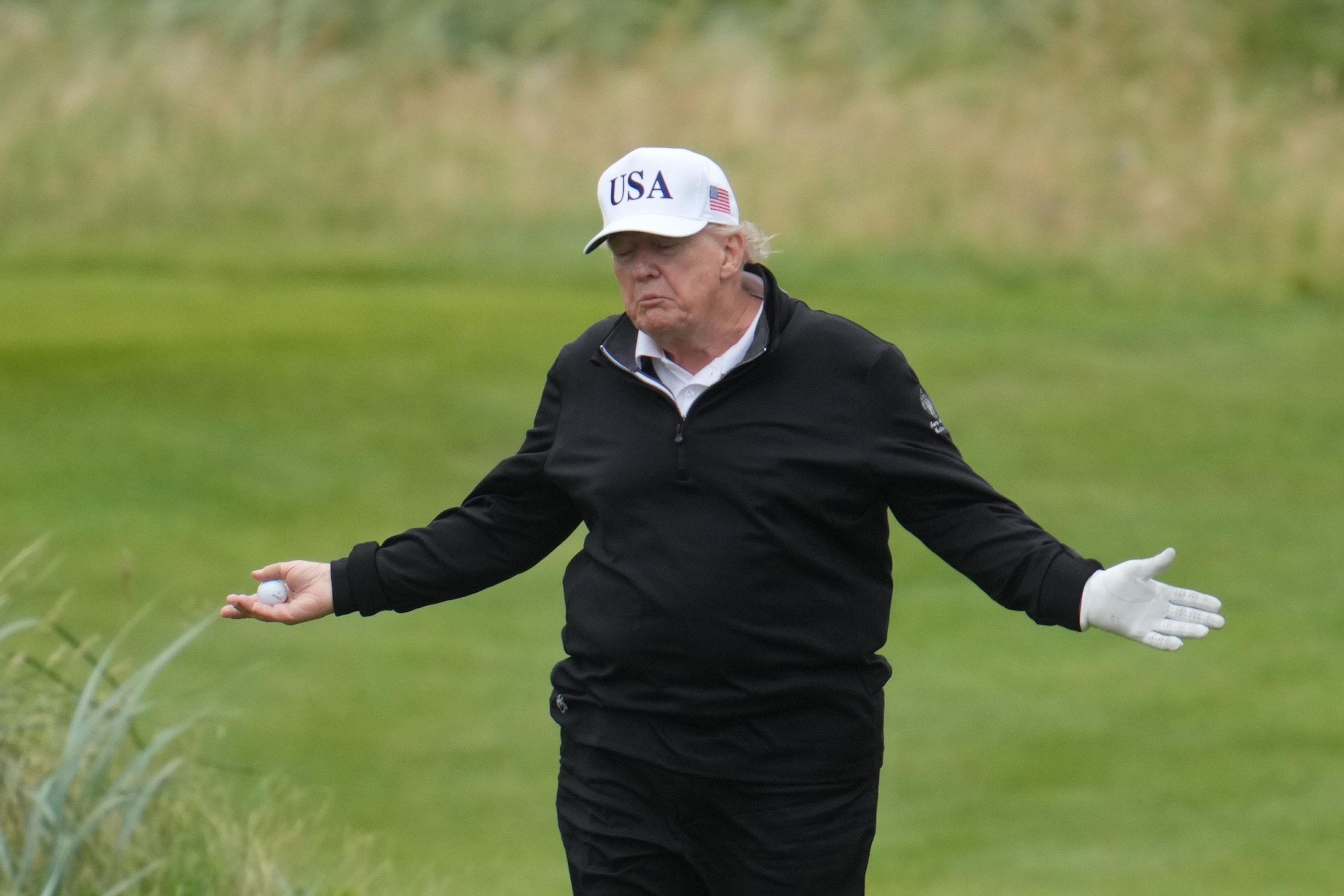 PHOTO: U.S. President Donald Trump reacts as he plays a round of golf at Trump Turnberry during his visit to the U.K. on July 27, 2025, in Turnberry, Scotland. Trump is also visiting Trump International Golf Links in Aberdeenshire during his trip.