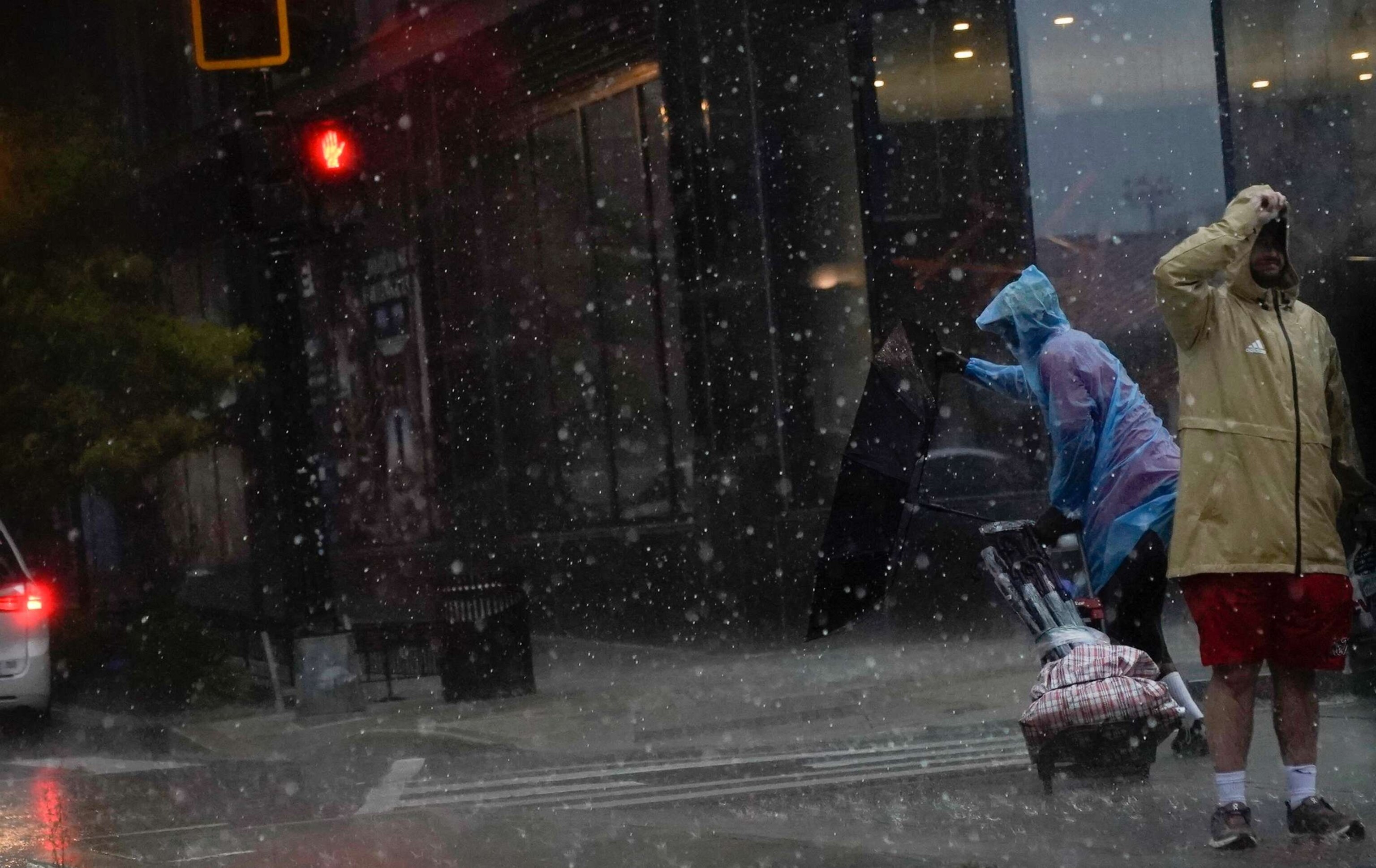 PHOTO: An umbrella is blown inside out as a person crosses the street during a storm in Washington, D.C., on Aug. 7, 2023.