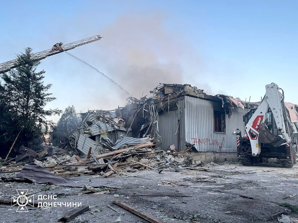 PHOTO: This handout picture taken and released by Ukrainian State Emergency Service on July 16, 2025, shows firefighters extinguishing a fire in Dobropillia, Donetsk region, after a Russian airstrike.