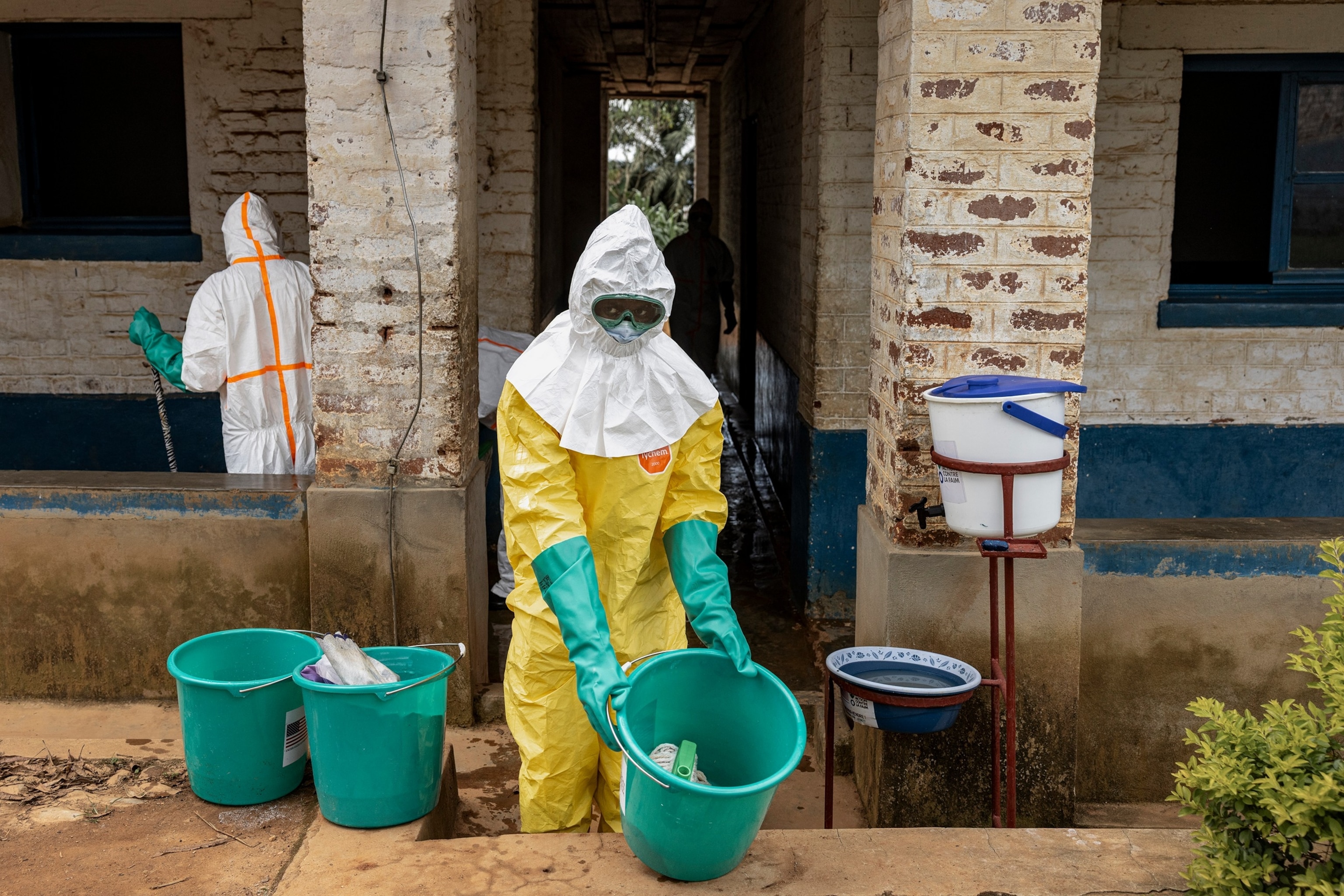 PHOTO: A health worker carries disinfectant materials while cleaning parts of the General Referral Hospital of Mongbwalu during Ebola response operations, May 23, 2026 in Mongbwalu, Ituri Province, Democratic Republic of Congo. 