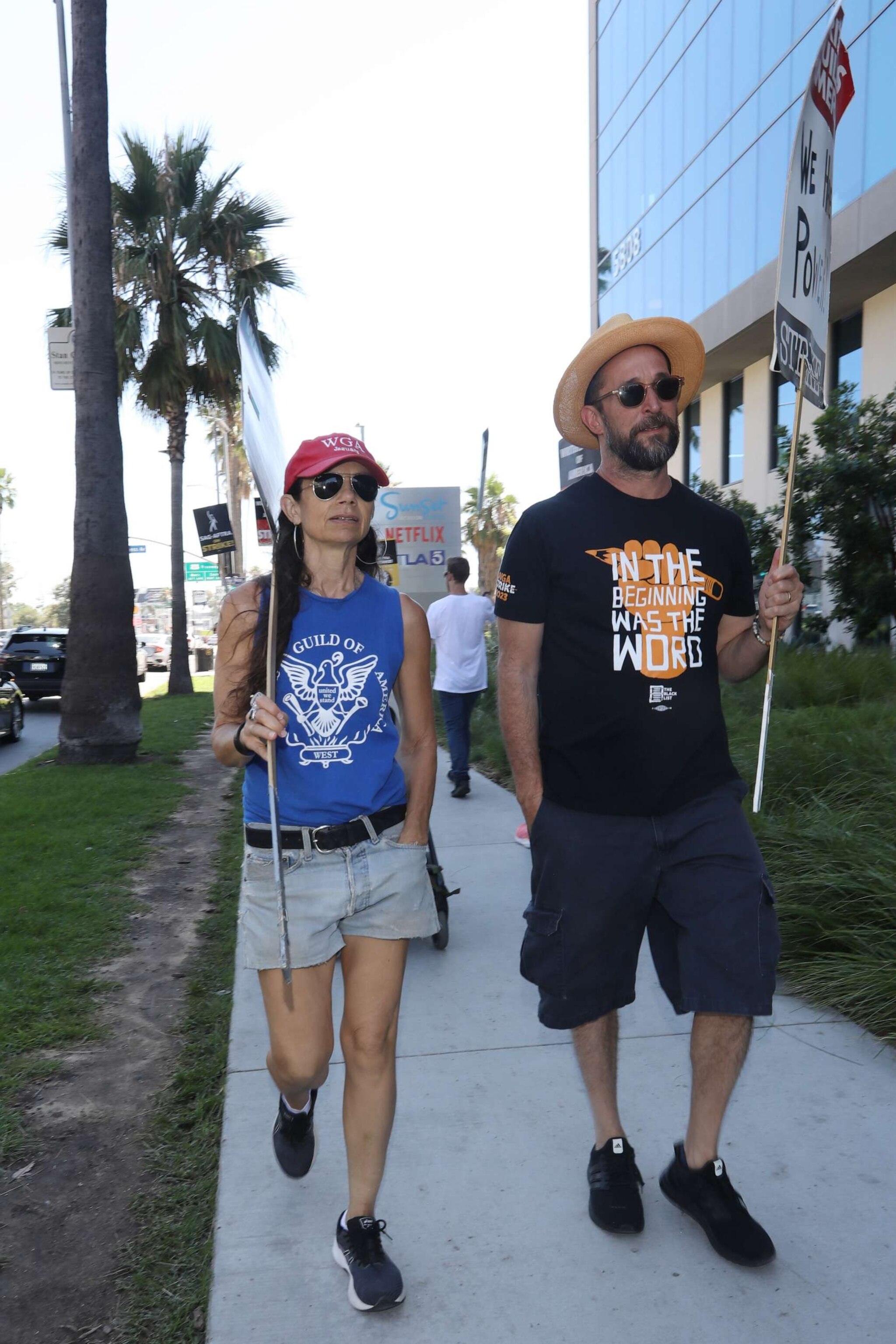 PHOTO: Justine Bateman and Noah Wylie walk the picket line in support of the SAG-AFTRA and WGA strike on Aug. 23, 2023 at Paramount Studios in Hollywood, Calif.