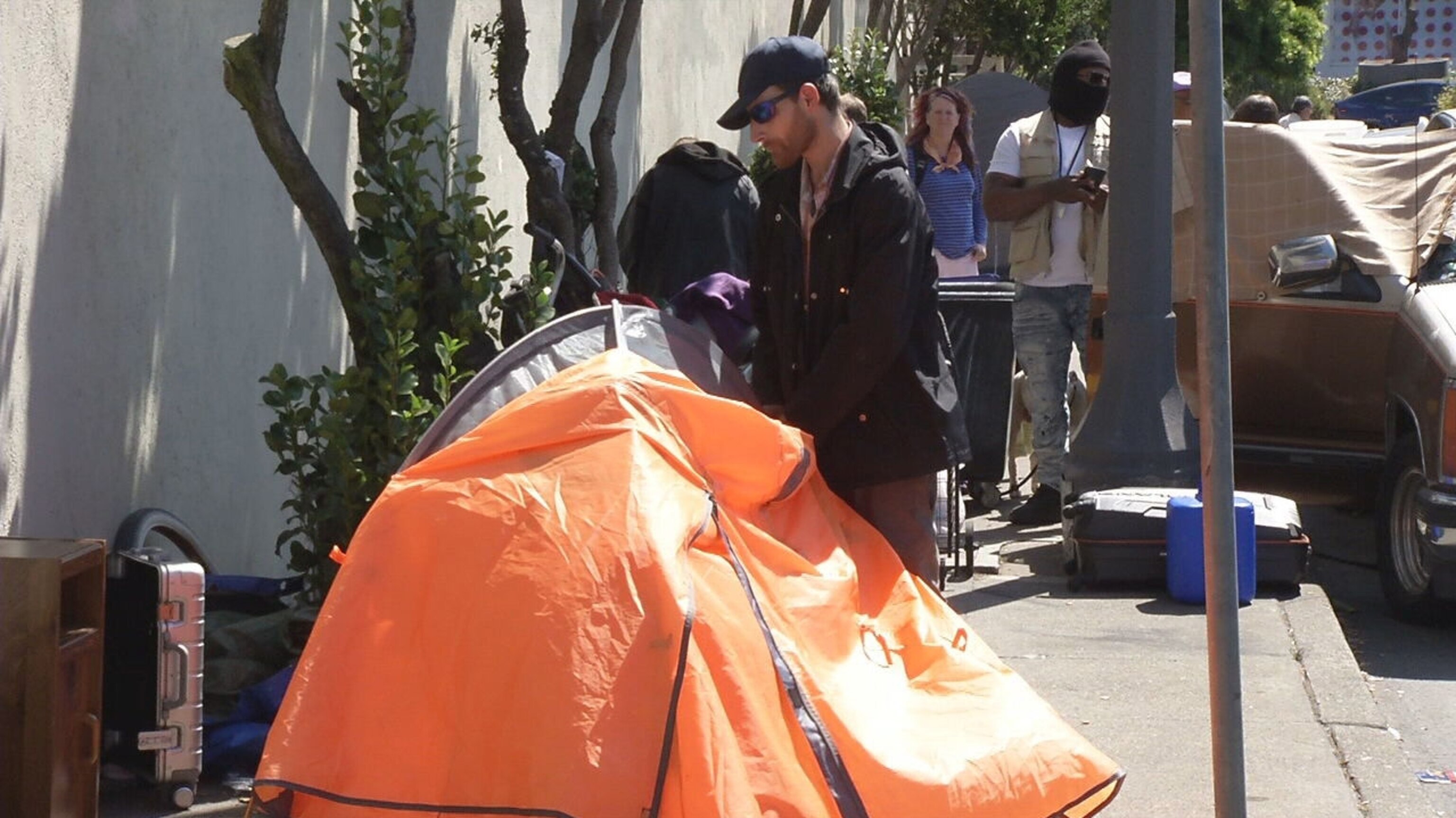 PHOTO: An unhoused former restaurant worker packs up his tent on the streets of San Francisco.