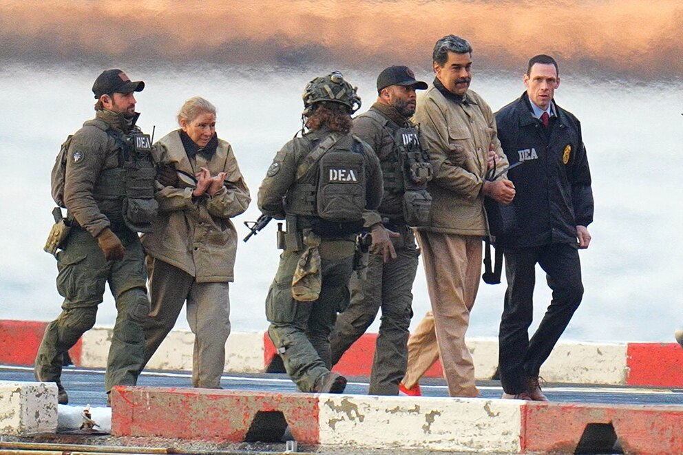 PHOTO: In this Jan. 5, 2026, file photo, Nicolas Maduro and his wife, Cilia Flores, are seen in handcuffs after landing at a Manhattan helipad, as they make their way into an armored car en route to a Federal courthouse in New York.