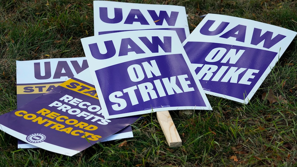 United Auto Workers signs for a strike are shown at the Stellantis Sterling Heights Assembly Plant, in Sterling Heights, Mich., Monday, Oct. 23, 2023. (AP Photo/Paul Sancya)