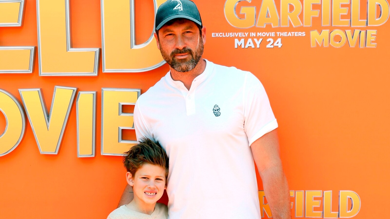 Maksim Chmerkovskiy hits the orange carpet with son Shai for 'Garfield