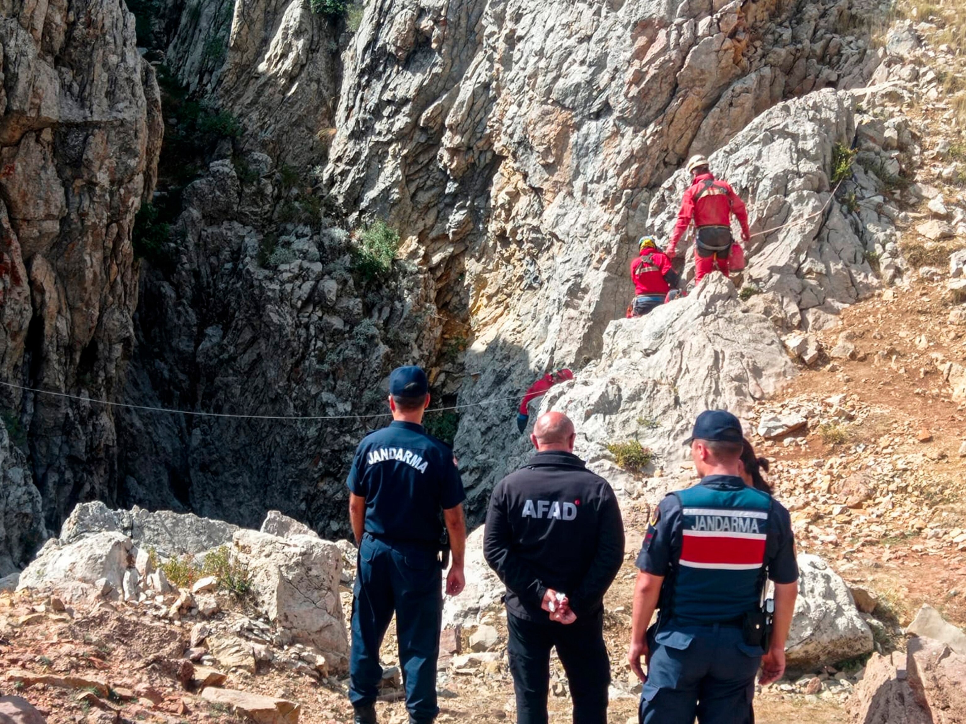 PHOTO: European Cave Rescue Association (ECRA) members and Turkish gendarmerie officers stand next to the entrance of Morca cave near Anamur, southern Turkey, Sept. 7, 2023.