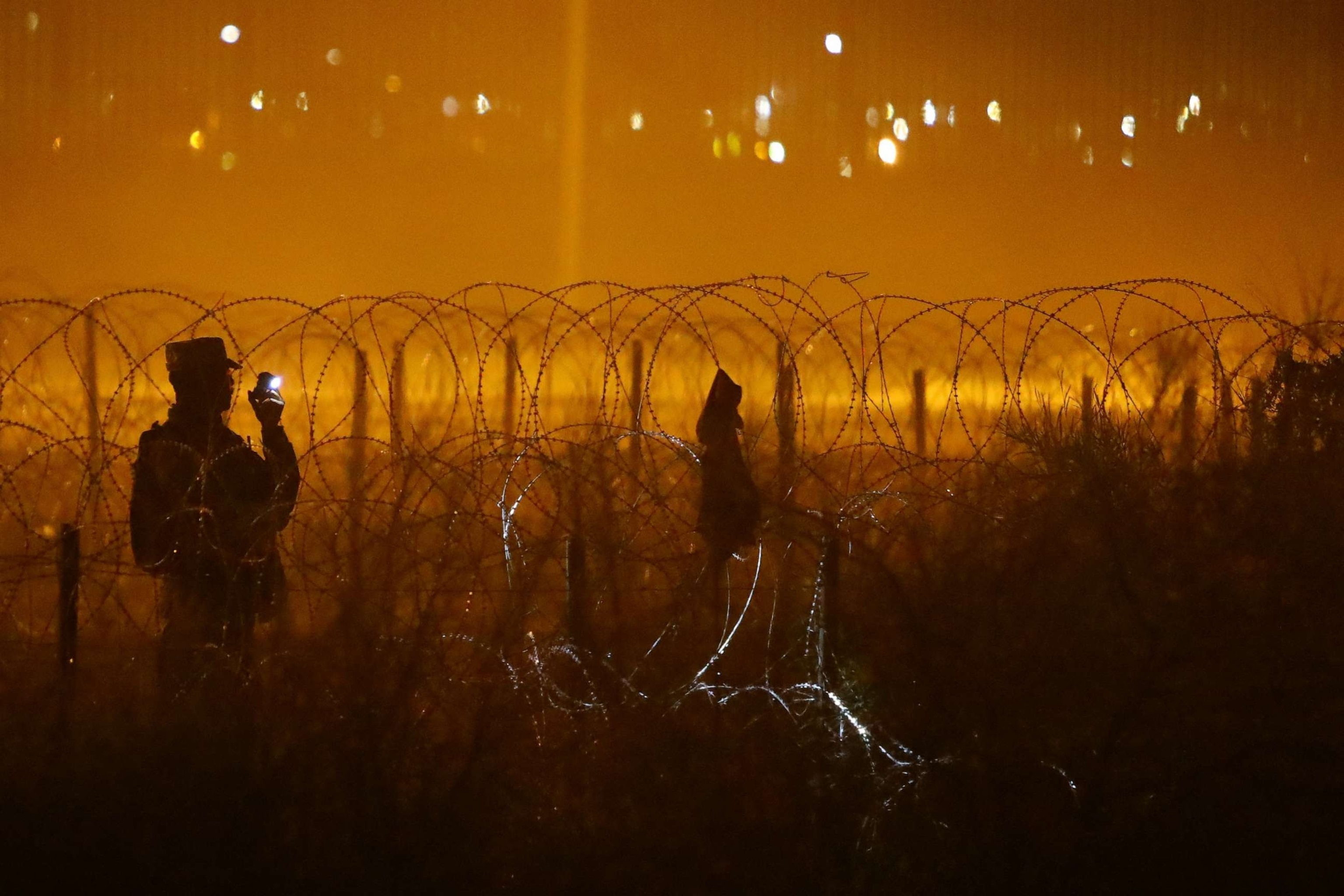 PHOTO: A member of the Texas National Guard stands guard on the banks of the Rio Bravo River, the border between the United States and Mexico as seen from Ciudad Juarez, Mexico, Oct. 17, 2023.