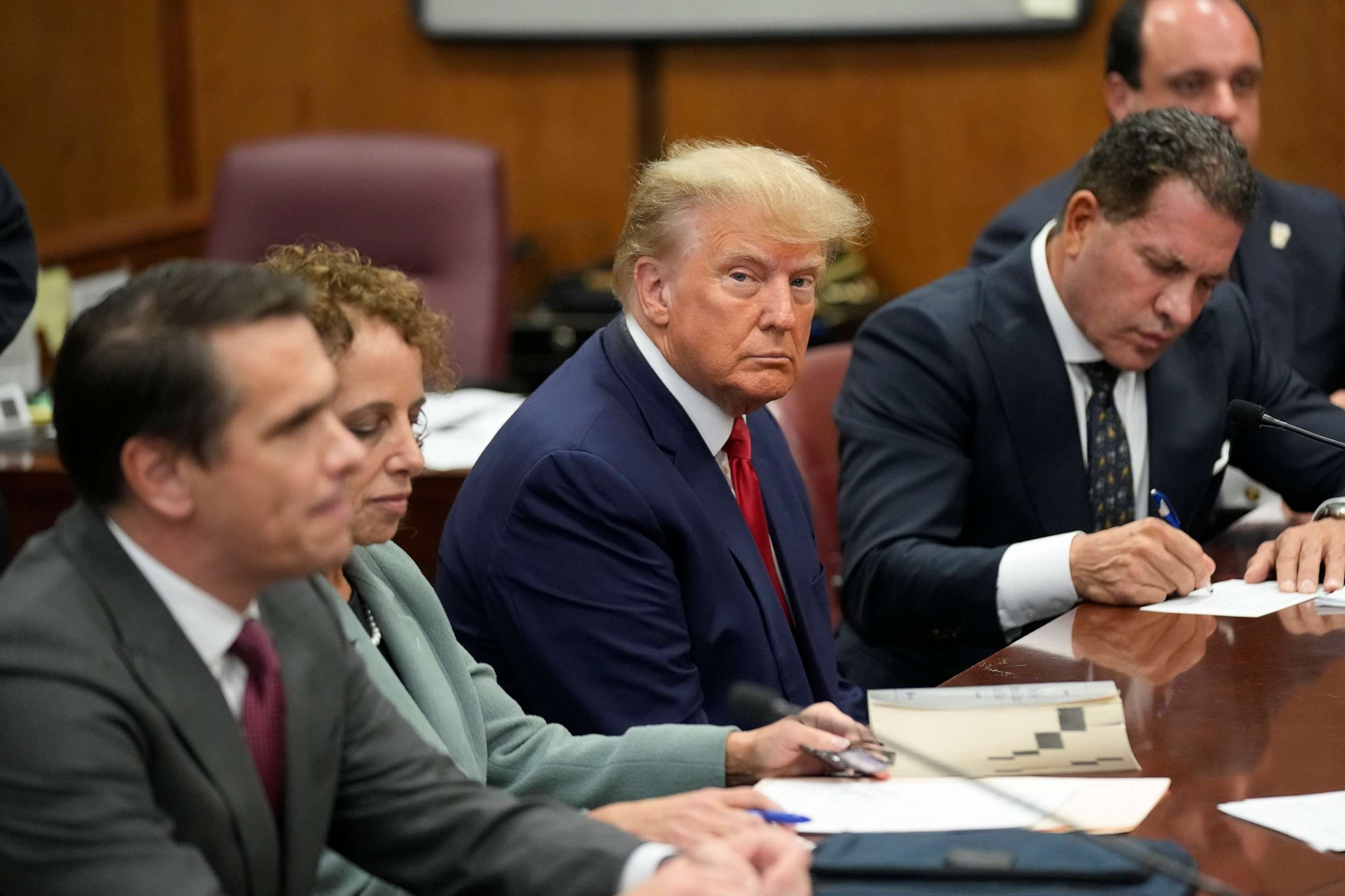 PHOTO: Former President Donald Trump sits with his defense team in a Manhattan court during his arraignment, April 4, 2023, in New York.