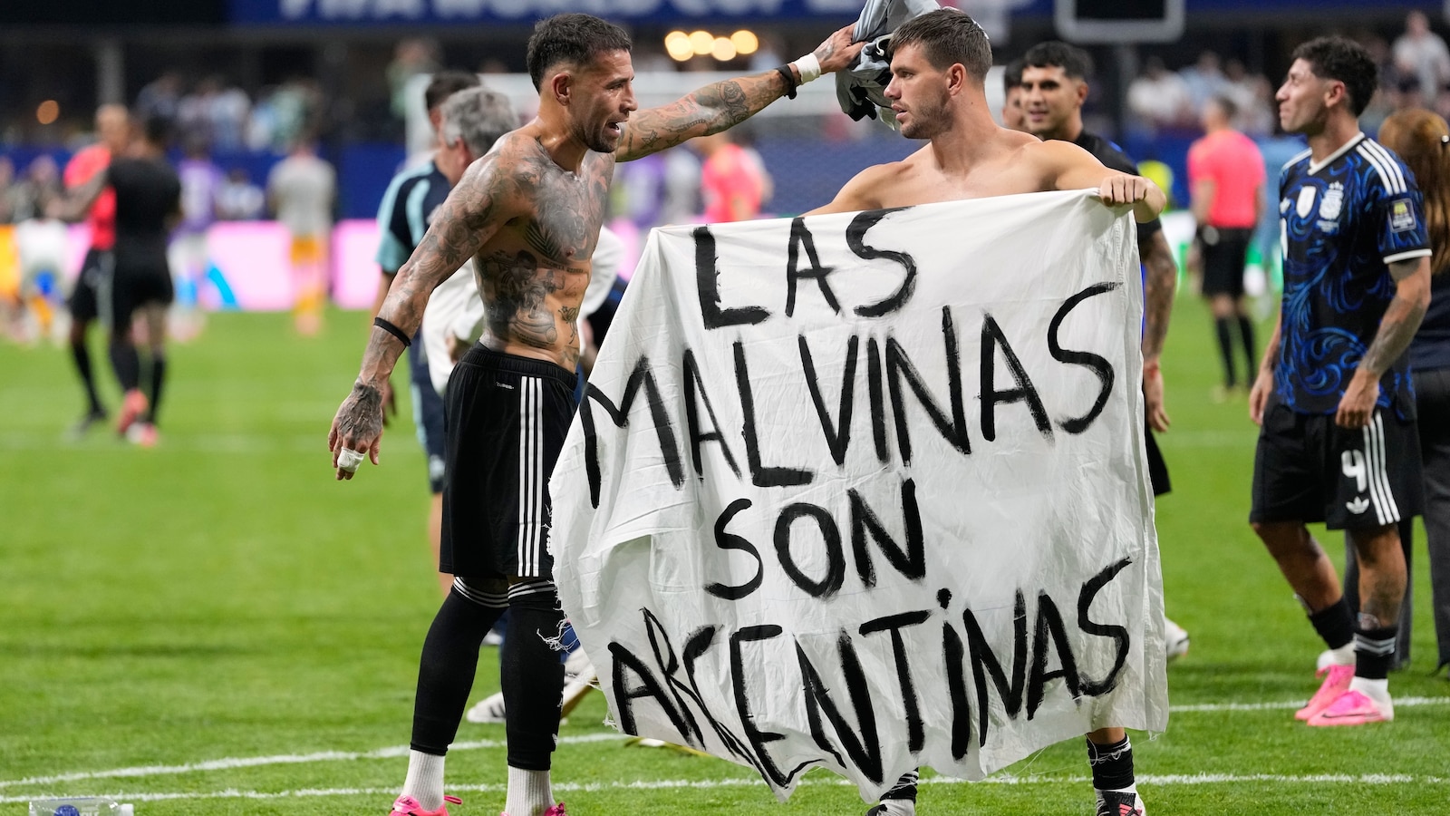 The British government on Thursday urged FIFA to investigate Argentina's team after players posed with a banner claiming sovereignty over the contested Falkland