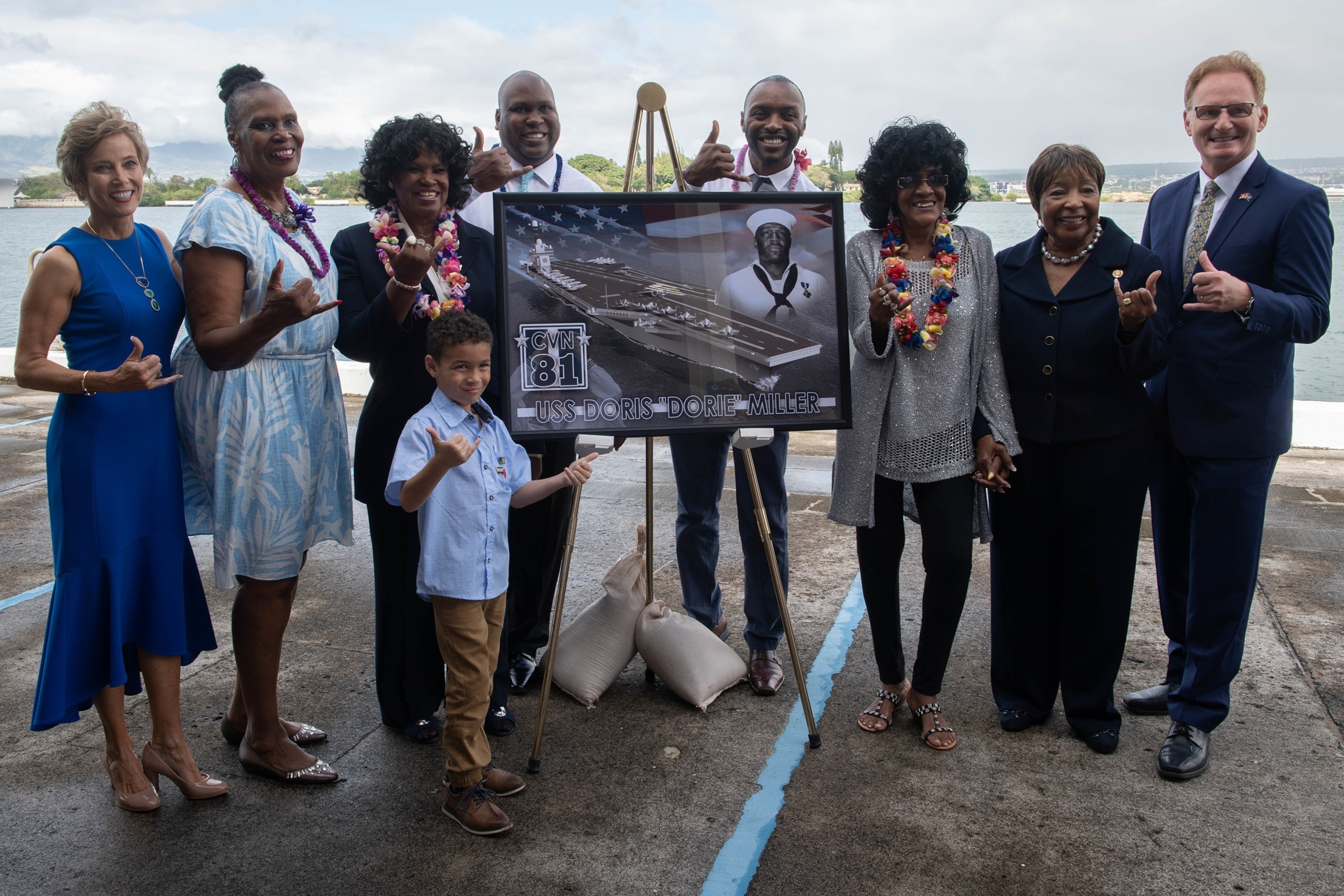 PHOTO: Acting Secretary of the Navy Thomas B. Modly poses for a photo with the Miller family after the unveiling of the new Ford-class aircraft carrier USS Doris Miller at an event on Joint Base Pearl Harbor-Hickam, Jan. 20, 2020. 