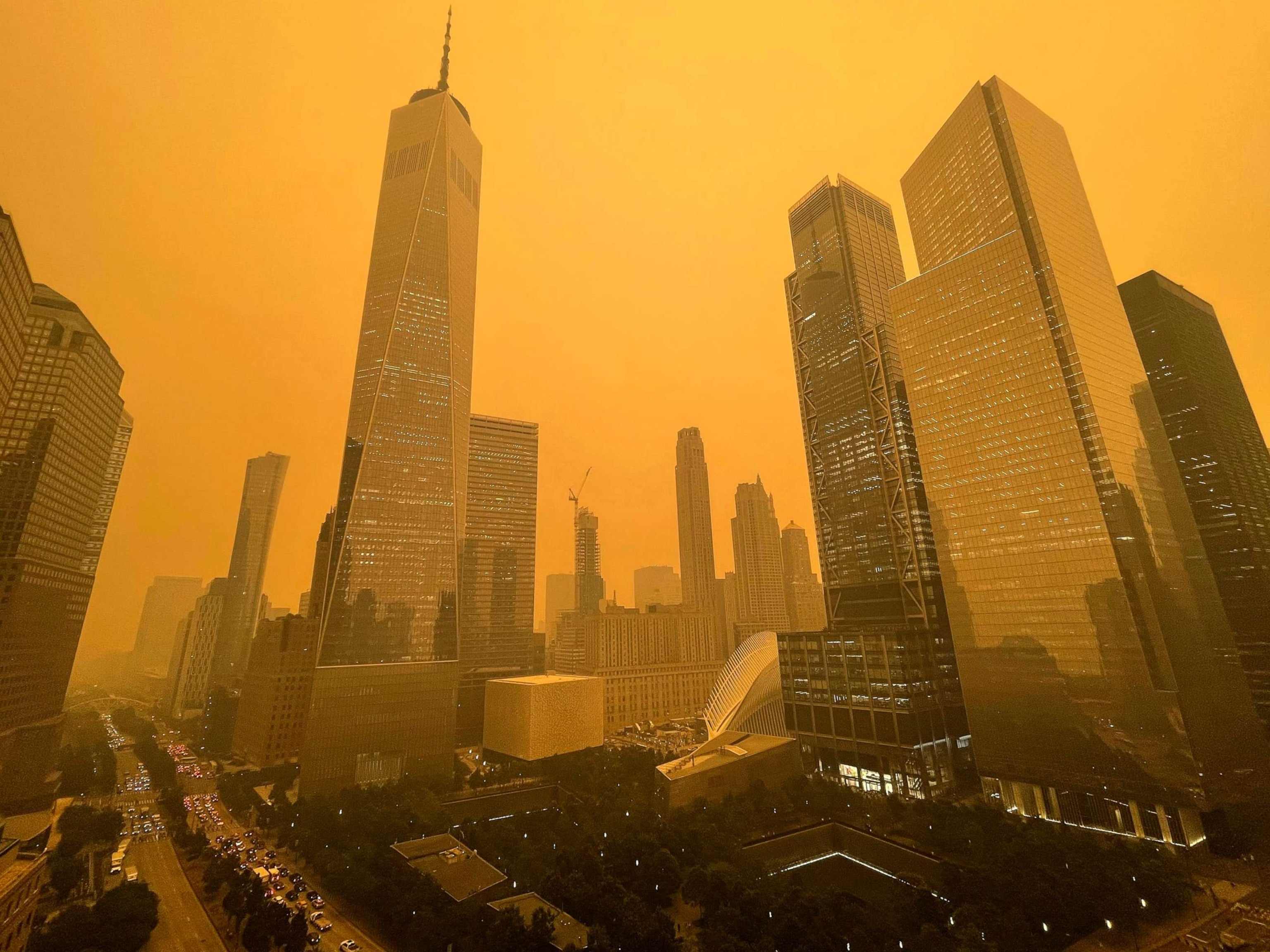 PHOTO: Traffic moves along West Street past One World Trade Center, June 7, 2023, in New York, amidst smokey haze from wildfires in Canada.