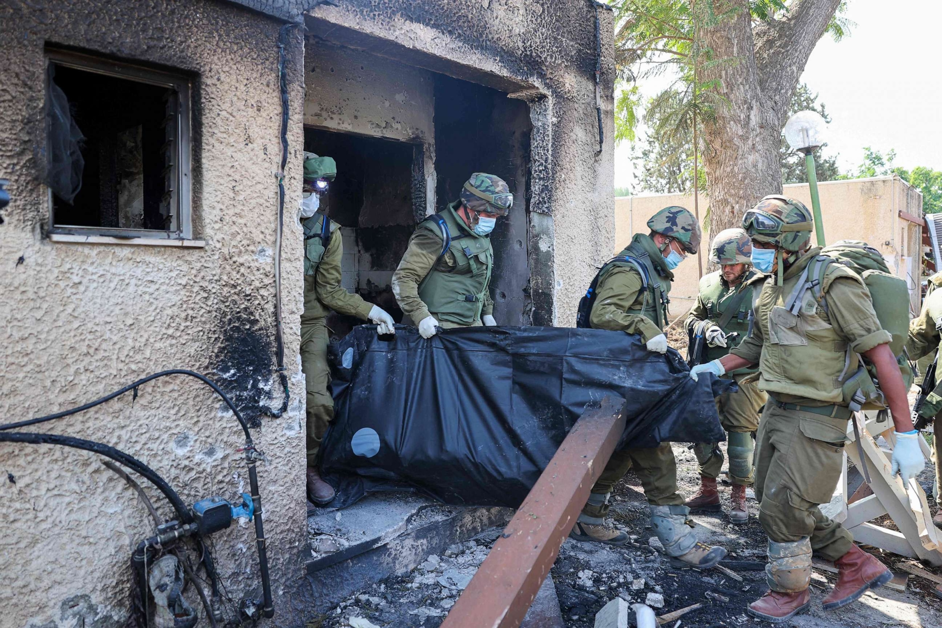 PHOTO: Israeli soldiers remove the body of a compatriot, killed during an attack by the Palestinian militants, in Kfar Aza, south of Israel bordering Gaza Strip, on Oct.10, 2023.