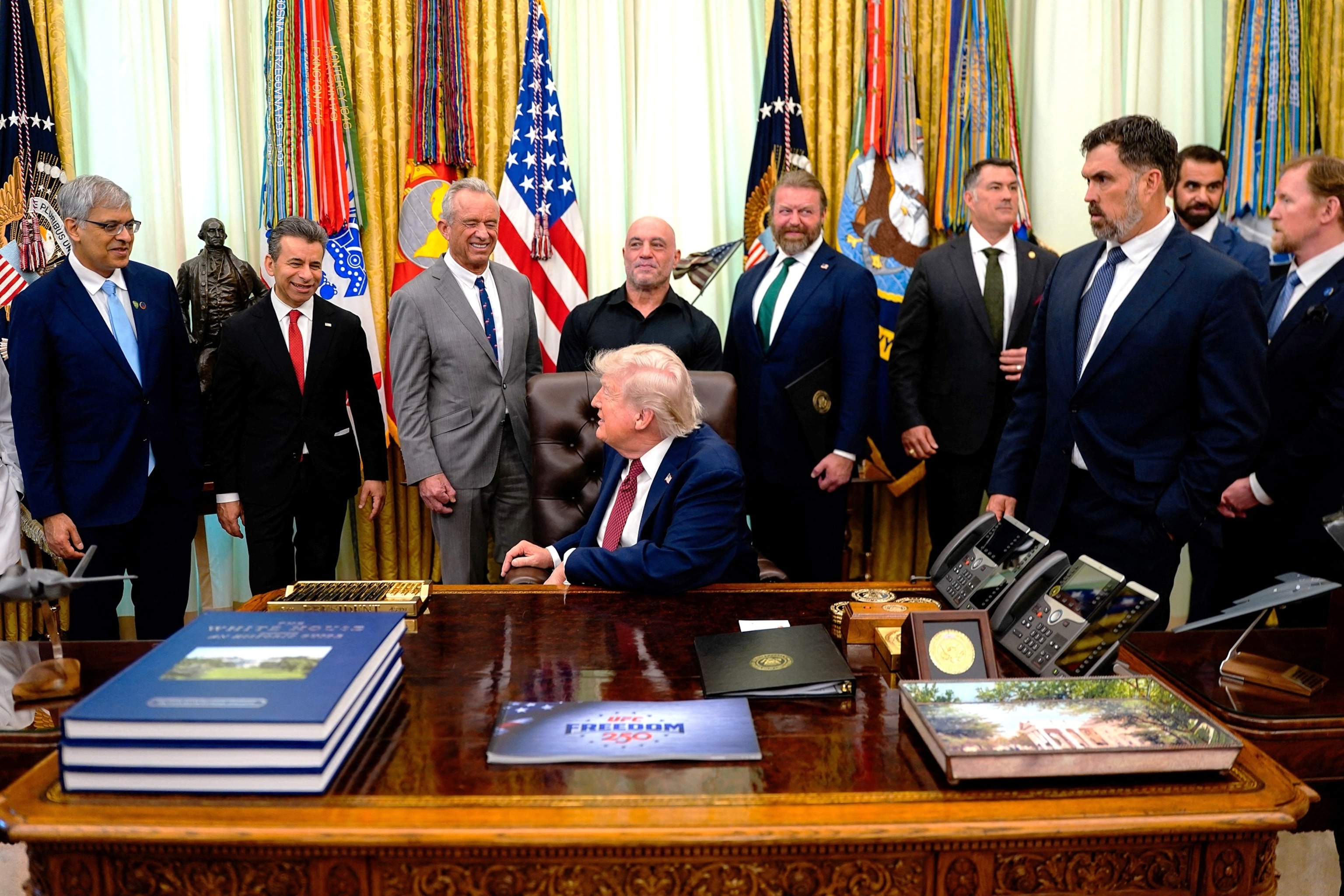 PHOTO: U.S. President Trump signs executive order about easing restrictions on mental health treatments, at the White House